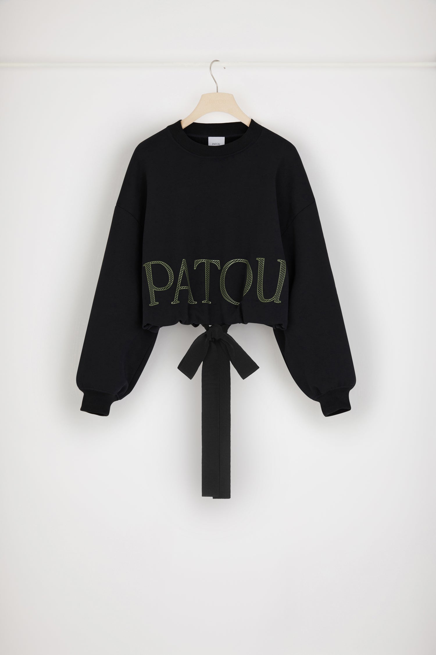 Patou - Cropped drawstring sweatshirt in organic cotton - Black - Grosgrain makes a big statement. Black organic cotton sweatshirt. Cropped silhouette. Crewneck. Ribbed collar and cuffs. Dropped shoulders. Patou logo in hatched lettering. Grosgrain drawstring hem. Loose fit (select one size down for a fitted look).