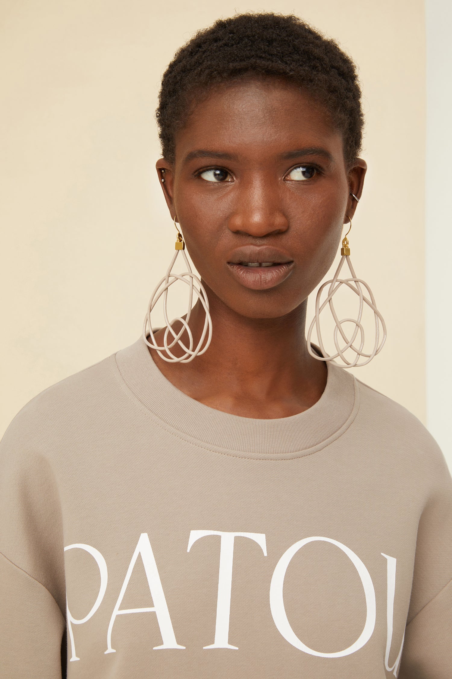 Patou - Wicker earrings - Dove - Lighter, brighter, our favourite earrings are made of wicker.Dove grey painted wicker earrings. Symmetric curved shape. Hook fastening suitable for pierced ears.