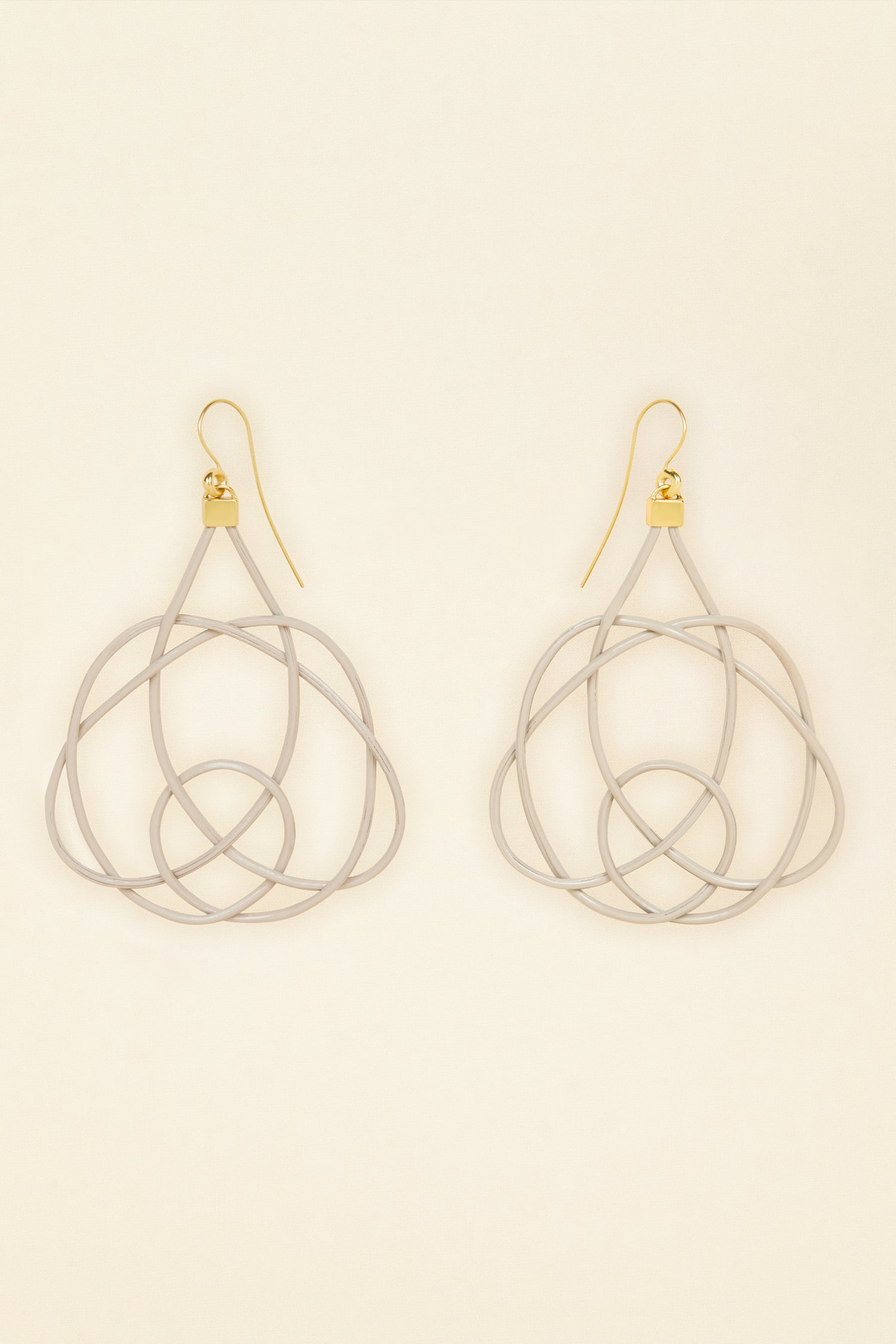 Patou - Wicker earrings - Dove - Lighter, brighter, our favourite earrings are made of wicker.Dove grey painted wicker earrings. Symmetric curved shape. Hook fastening suitable for pierced ears.
