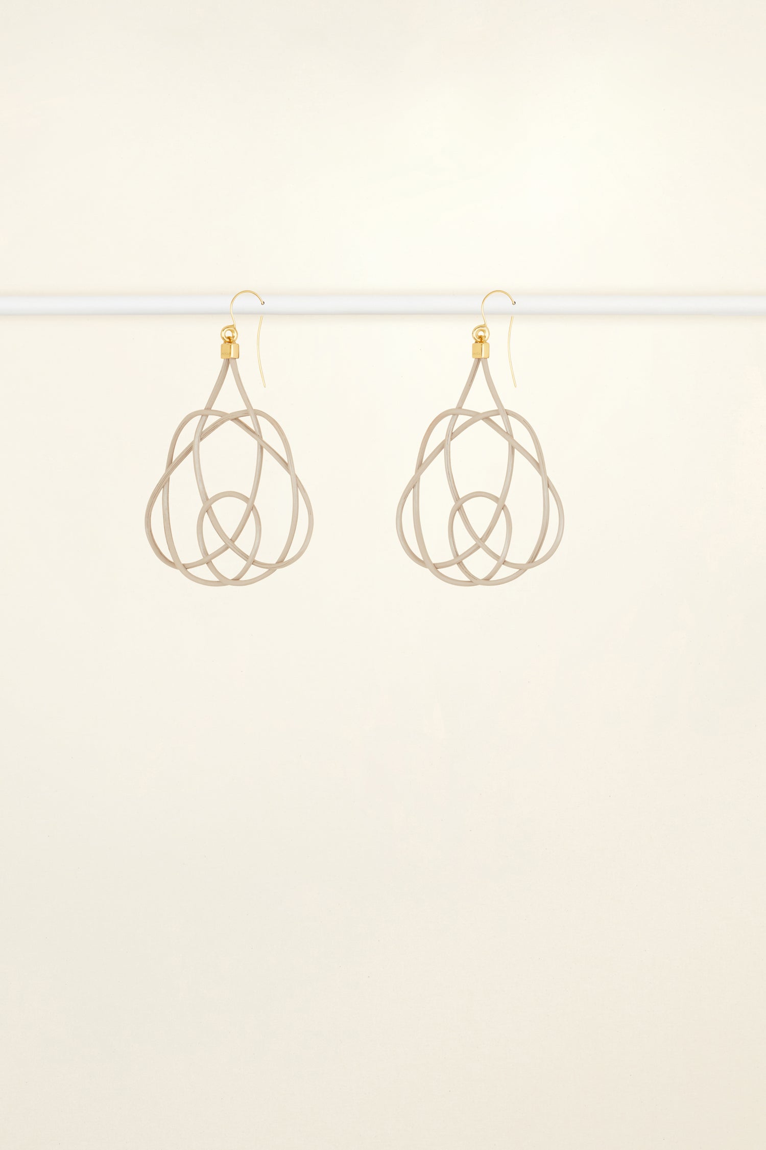Patou - Wicker earrings - Dove - Lighter, brighter, our favourite earrings are made of wicker.Dove grey painted wicker earrings. Symmetric curved shape. Hook fastening suitable for pierced ears.