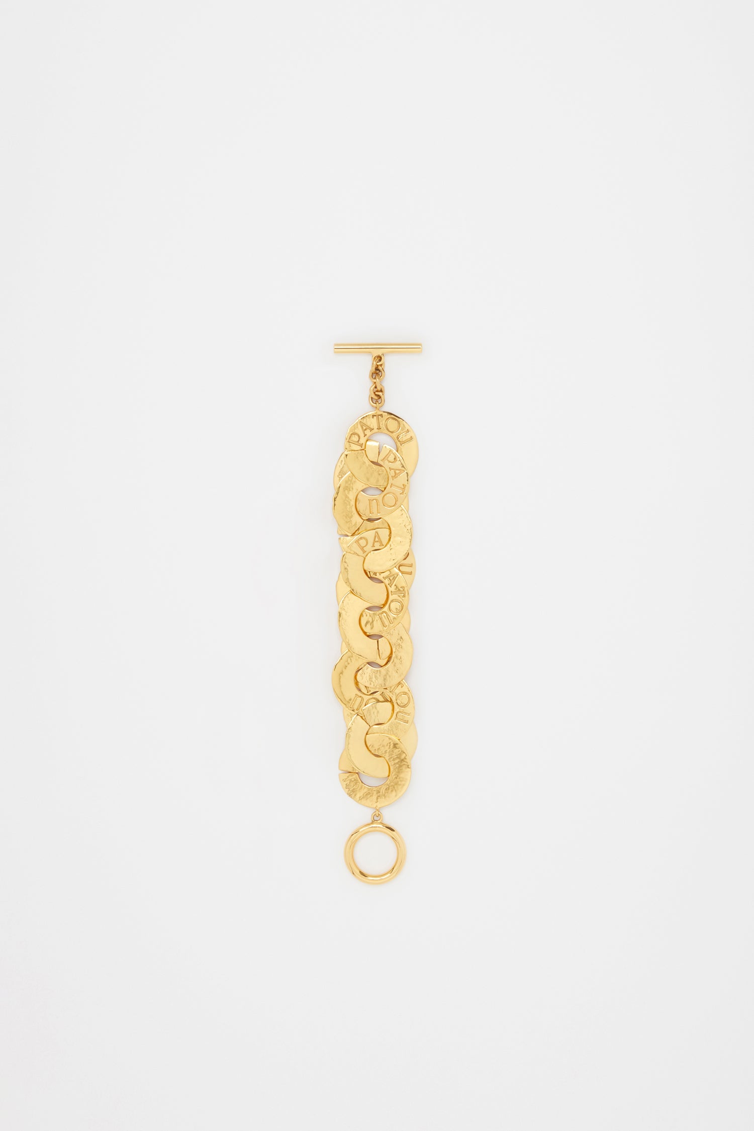 Patou - Coin bracelet in gold-plated brass - Gold - Gold-plated brass bracelet. Antique coin inspiration. Hammered texture. Interlinked coin chain with-engraved Patou logo. T-bar closure.