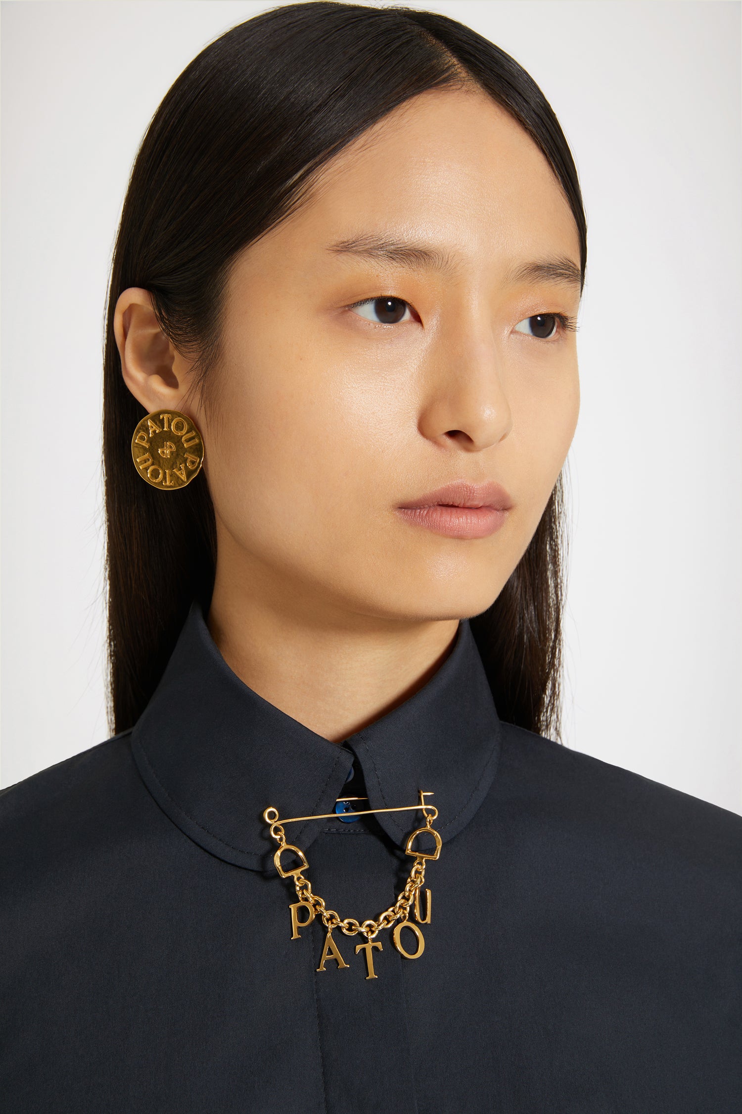 Patou - Patou brooch in gold-plated brass - Gold - A lucky charm spelt Patou.Gold-plated brass brooch. Safety pin-inspired shape with thin chain and Patou letter charms.