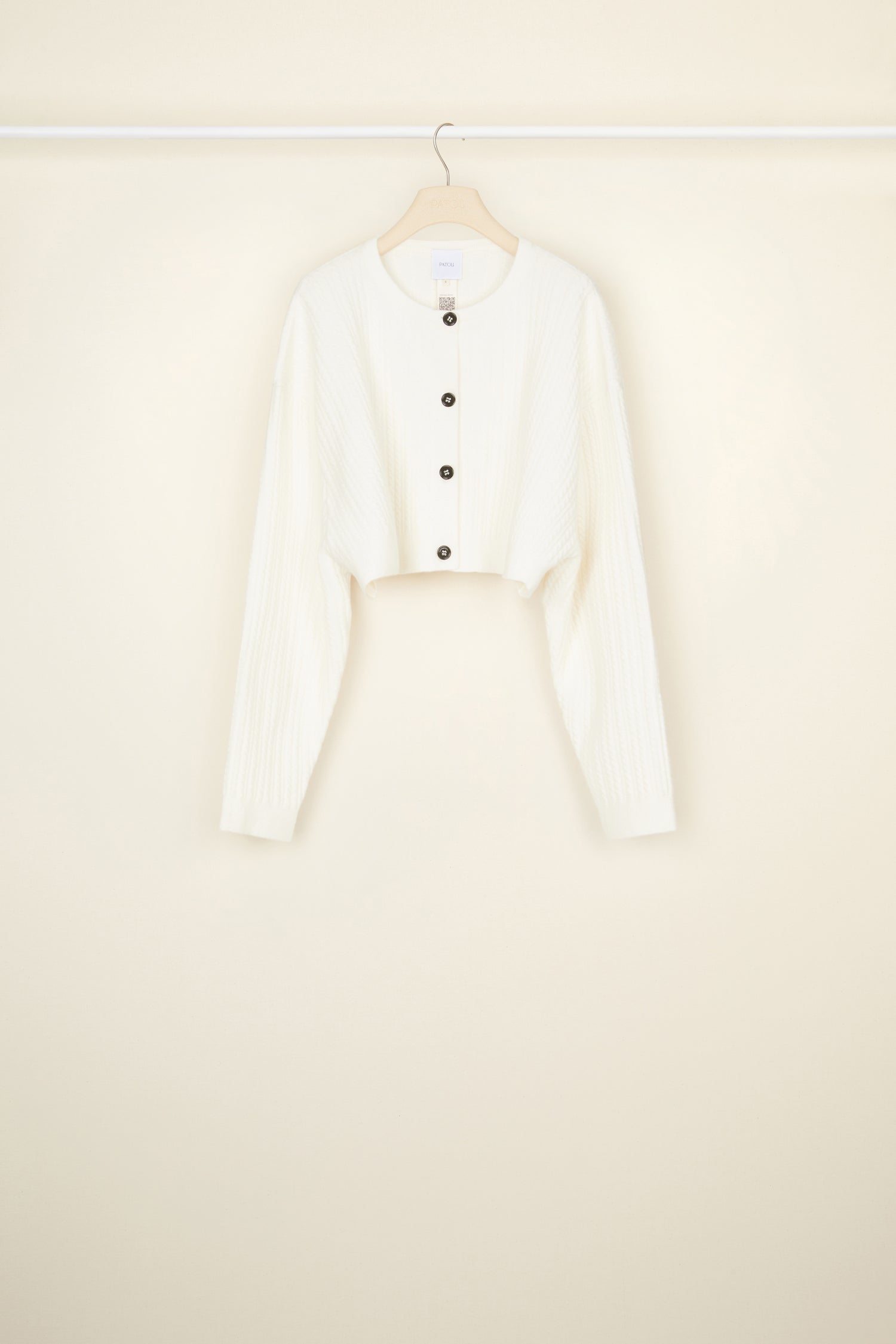 Patou - Cropped cable knit cardigan in recycled wool blend - White - Cable + cropped: the new knitwear equation.White recycled wool blend cardigan. Cropped silhouette. 3D cable knit detailing. Round neckline. Button fastening at the front with JP engraved buttons.