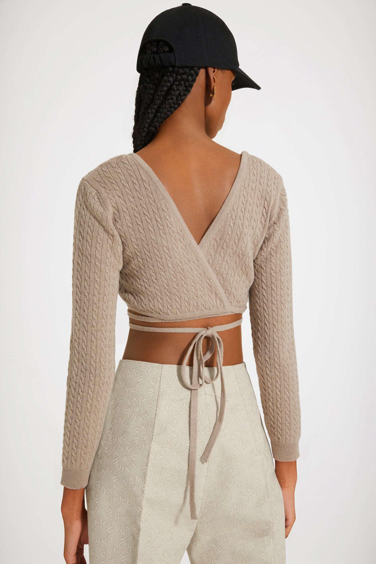 Patou - Wrap-back cable knit top in wool and cashmere - Parchment - A cable knit top wraps the body in alluring architectures.Parchment beige wool and cashmere top. Cable knit. Cropped silhouette. Sweetheart neckline. Trompe-l'oeil wrap back. Ties that wrap around the waist.