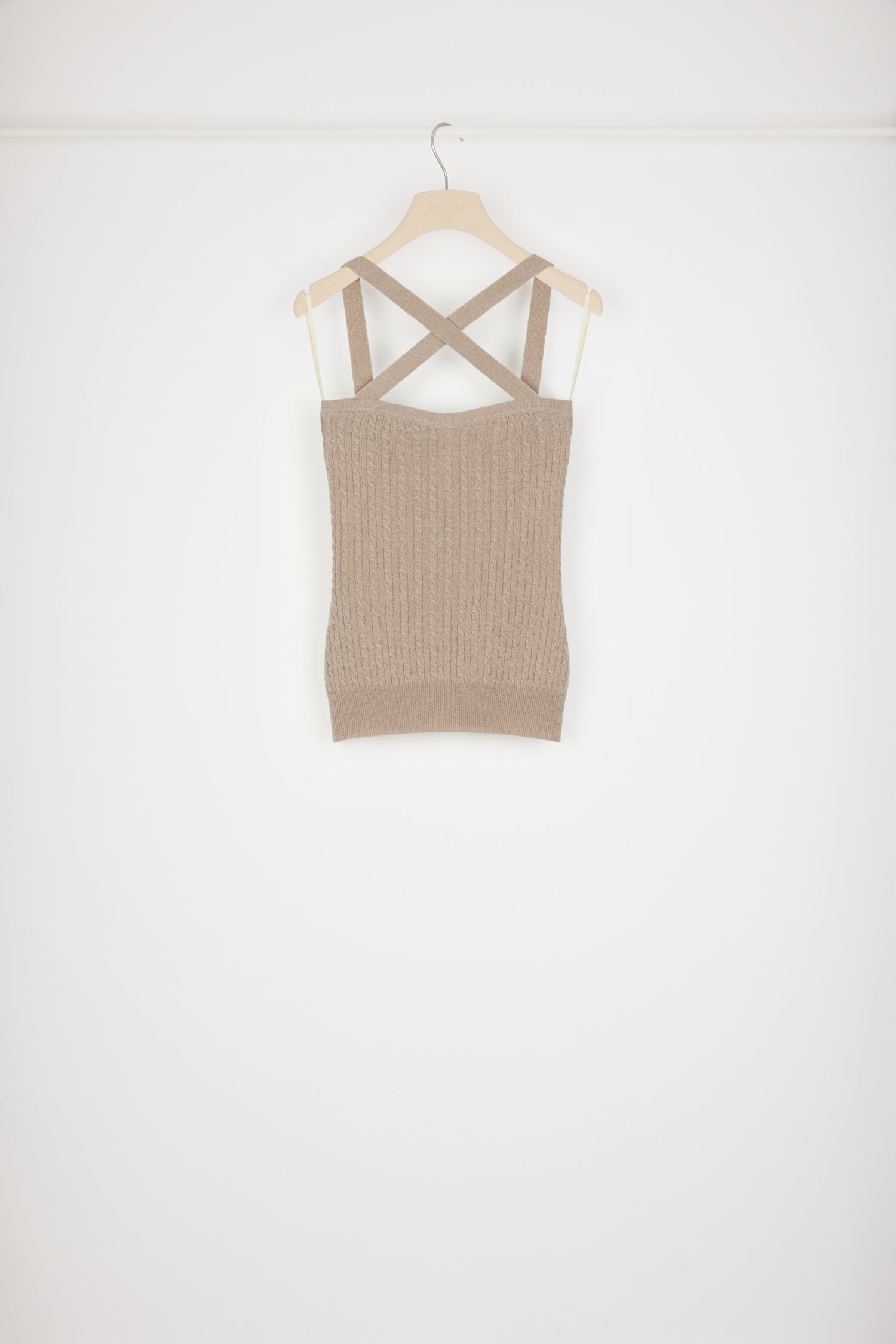 Patou - Cross-strap cable knit top in wool and cashmere - Parchment - X marks the sweet spot.Parchment beige wool and cashmere top. Cable knit. Crossed straps at the front. Slight sweetheart neckline. JP monogram appliqué at the back. Ribbed waistband. This top is very skin-tight.
