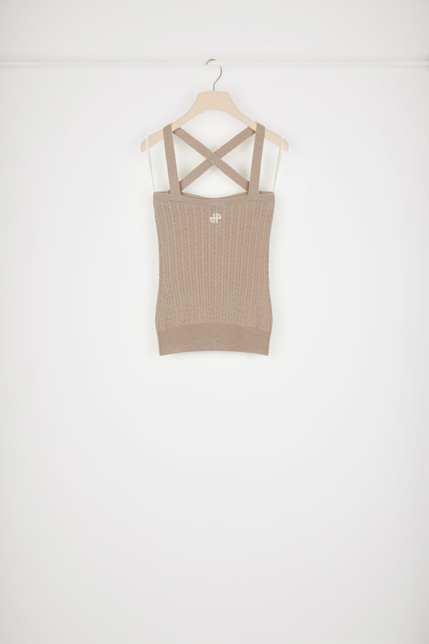 Patou - Cross-strap cable knit top in wool and cashmere - Parchment - X marks the sweet spot.Parchment beige wool and cashmere top. Cable knit. Crossed straps at the front. Slight sweetheart neckline. JP monogram appliqué at the back. Ribbed waistband. This top is very skin-tight.