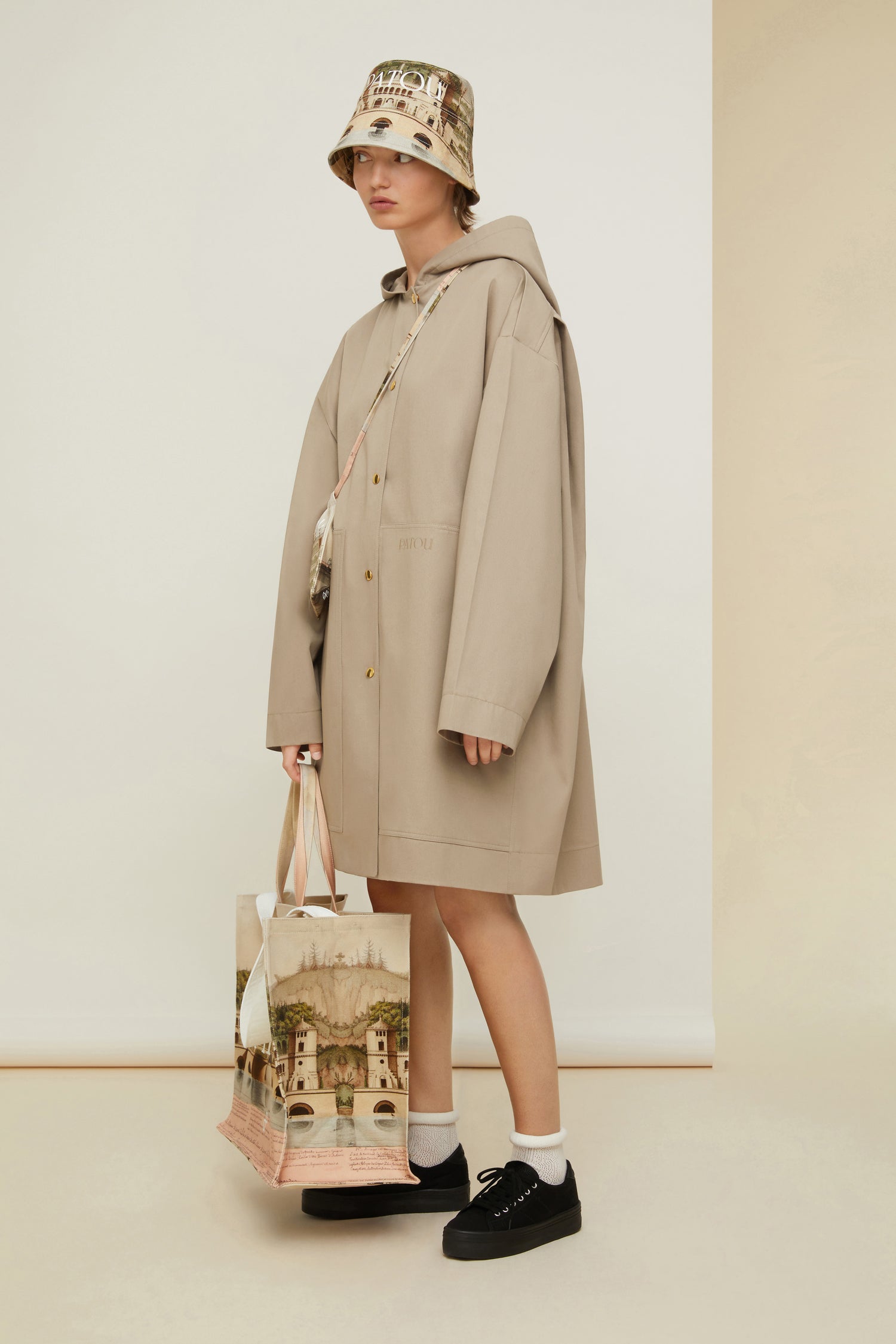 Patou - Puss in Boots oversized parka in organic cotton - Parchment - Ready to brave the elements with a smile. So Patou!Parchment beige organic cotton parka. Oversized silhouette. Hooded collar. Dropped embossed shoulders. Stud button fastening at the front. Large patch pockets. Patou lettering logo embroidered on the left pocket. Classic “Puss in Boots” illustration by Gustave Doré and Patou lettering logo printed at the back.Loose fit (select one size down for a fitted look).