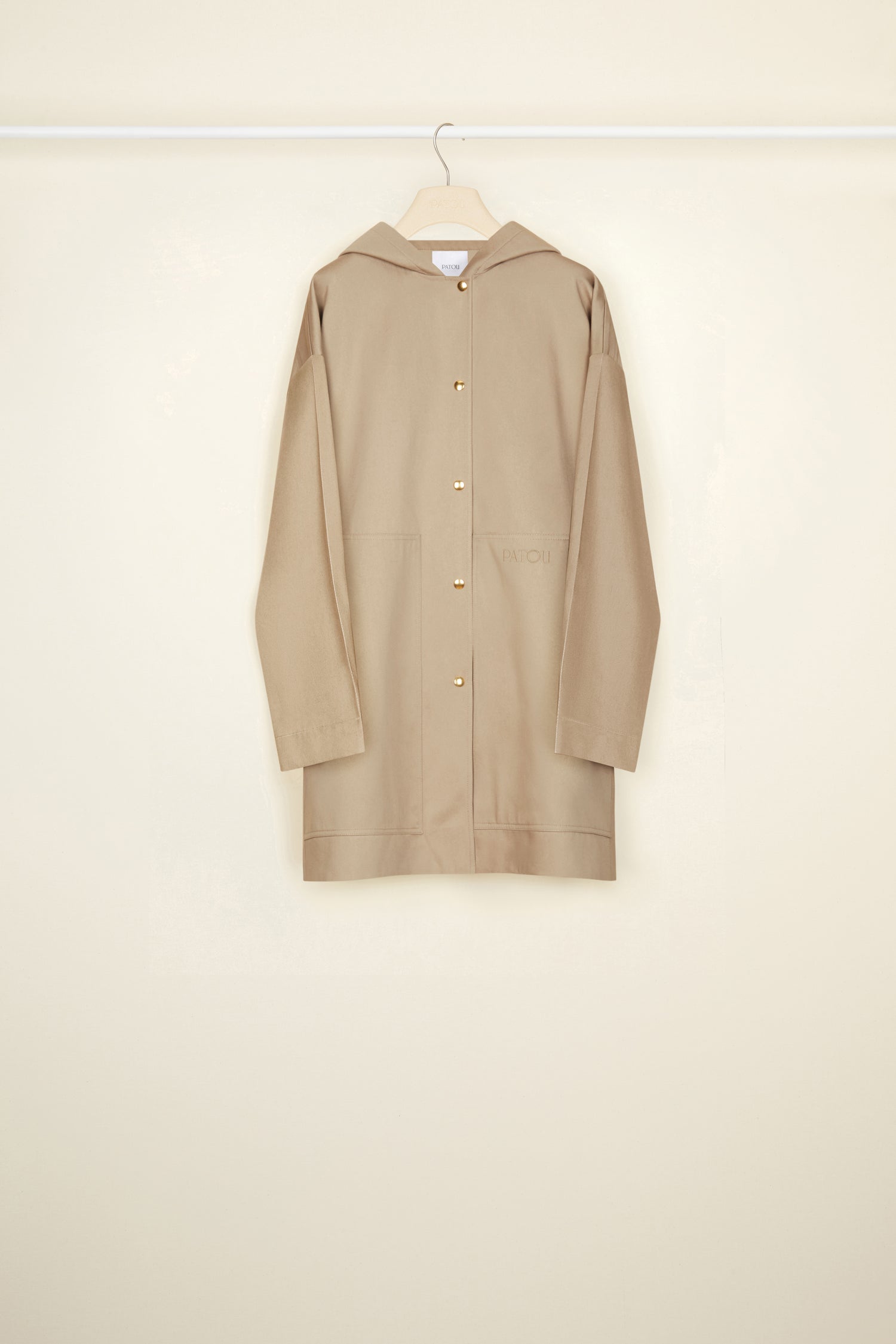 Patou - Puss in Boots oversized parka in organic cotton - Parchment - Ready to brave the elements with a smile. So Patou!Parchment beige organic cotton parka. Oversized silhouette. Hooded collar. Dropped embossed shoulders. Stud button fastening at the front. Large patch pockets. Patou lettering logo embroidered on the left pocket. Classic “Puss in Boots” illustration by Gustave Doré and Patou lettering logo printed at the back.Loose fit (select one size down for a fitted look).