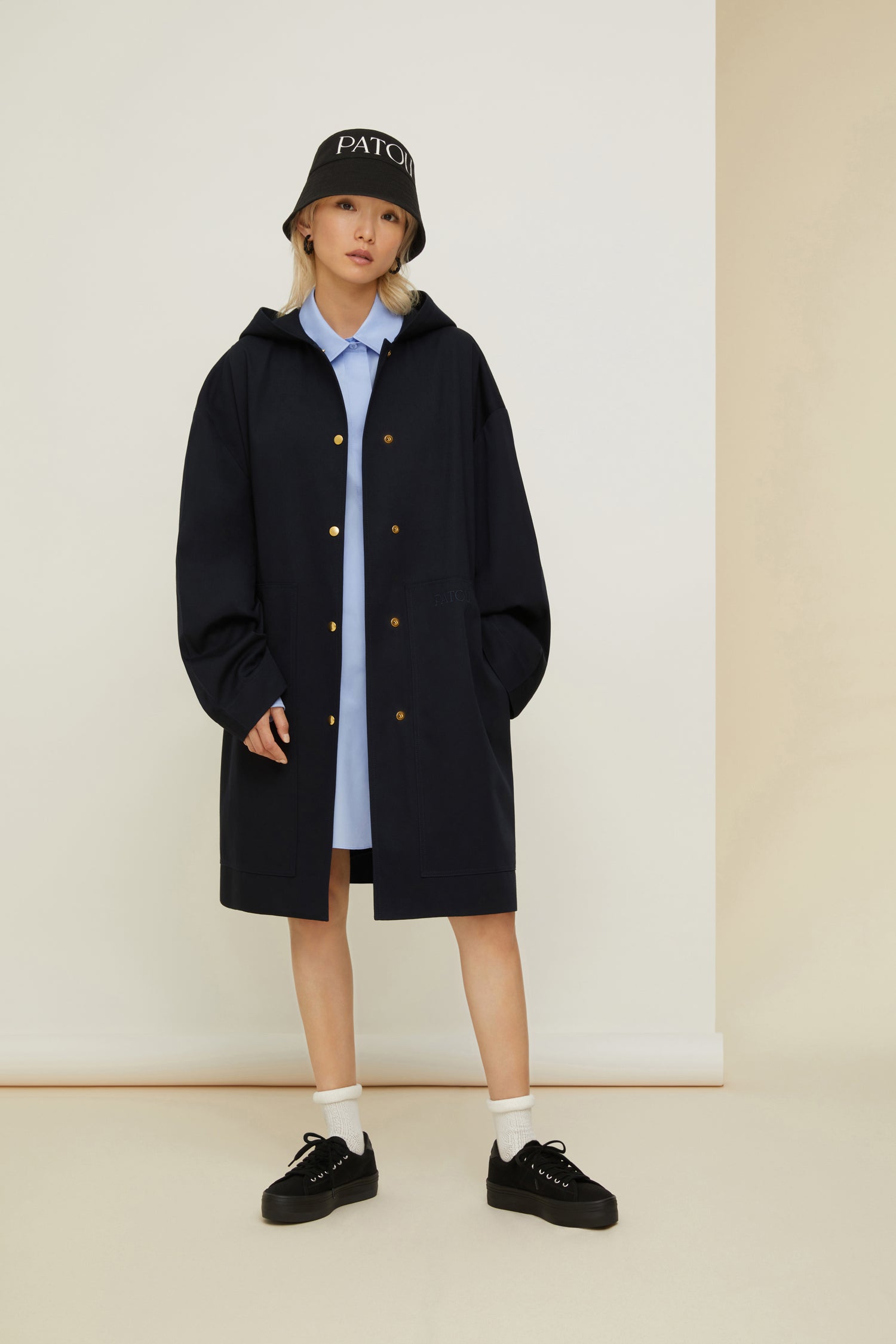 Patou - Patou oversized parka in organic cotton - Night Blue - Ready to brave the elements with a smile. So Patou!Night Blue organic cotton parka. Oversized silhouette. Hooded collar. Dropped embossed shoulders. Stud button fastening at the front. Large patch pockets. Patou lettering logo embroidered on the left pocket. Patou lettering logo printed at the back in white.Loose fit (select one size down for a fitted look).