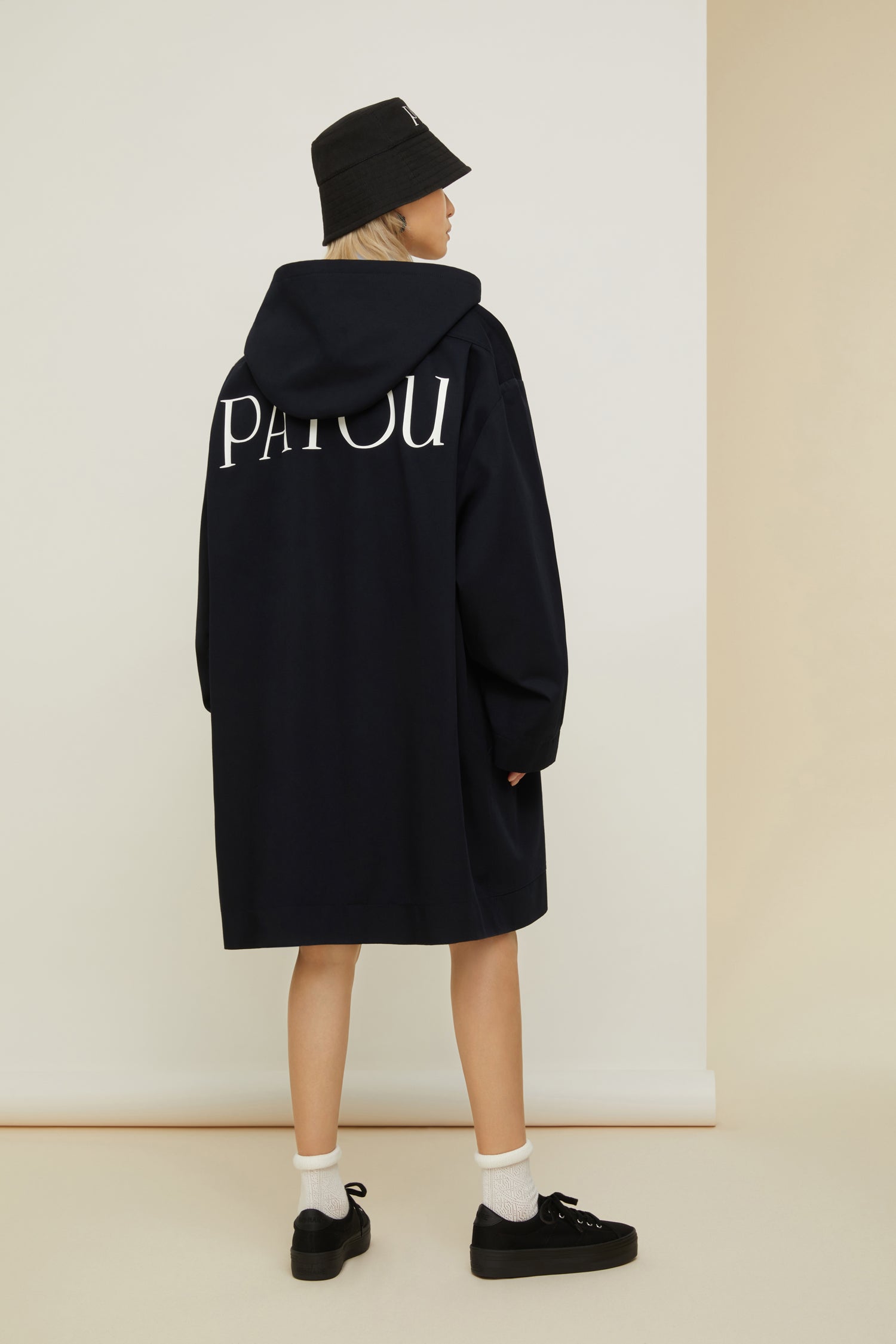 Patou - Patou oversized parka in organic cotton - Night Blue - Ready to brave the elements with a smile. So Patou!Night Blue organic cotton parka. Oversized silhouette. Hooded collar. Dropped embossed shoulders. Stud button fastening at the front. Large patch pockets. Patou lettering logo embroidered on the left pocket. Patou lettering logo printed at the back in white.Loose fit (select one size down for a fitted look).