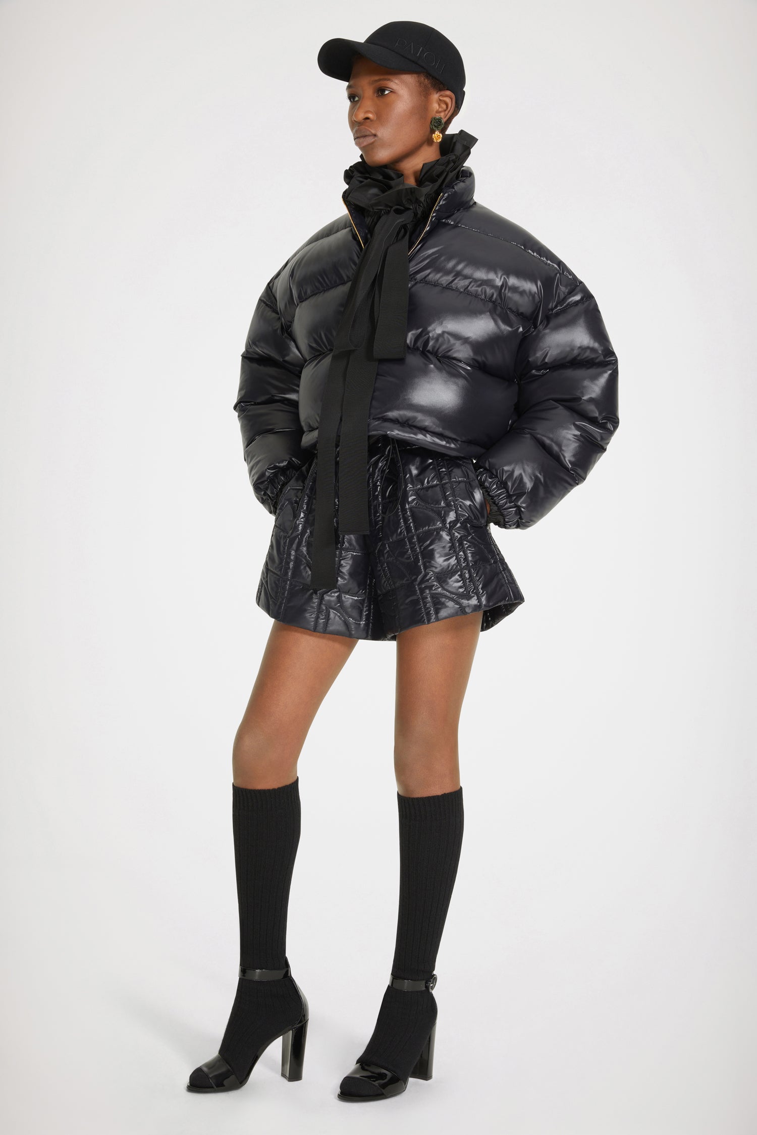 Patou - Patou puffer jacket - Black - A puffer named Patou. Black polyester blend jacket. Short padded style. High collar. Gold-tone zip with JP puller inspired by a heritage keyring from the Jean Patou archive. Large Patou logo across the back. Pockets at the sides. Drawstring waist. Elasticated cuffs.