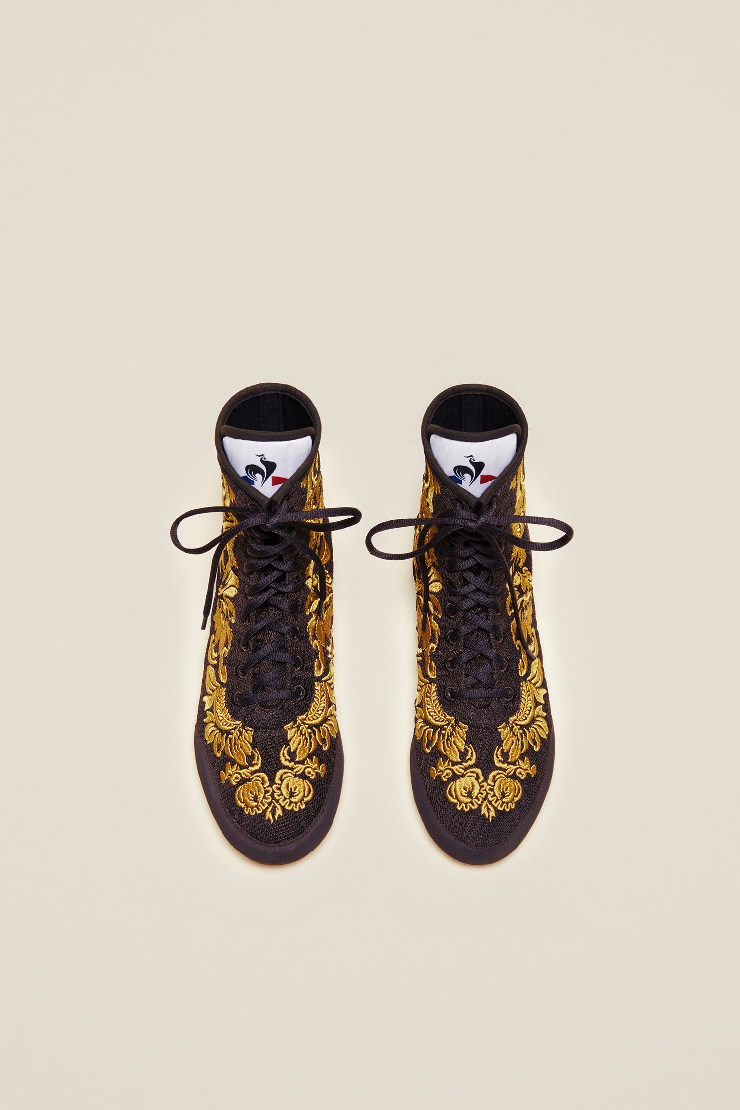 Patou - Embroidered high-top trainers - Havana - Havana - Couture florals are stepping in the ring!Ongoing collaboration between Patou and Le Coq Sportif. Brown high-top trainers inspired by classic boxing shoes. Gold floral embroideries. Patou logo engraved on the heel. Original Le Coq Sportif logo on the tongue. Flexible rubber sole with embossed Patou logo.