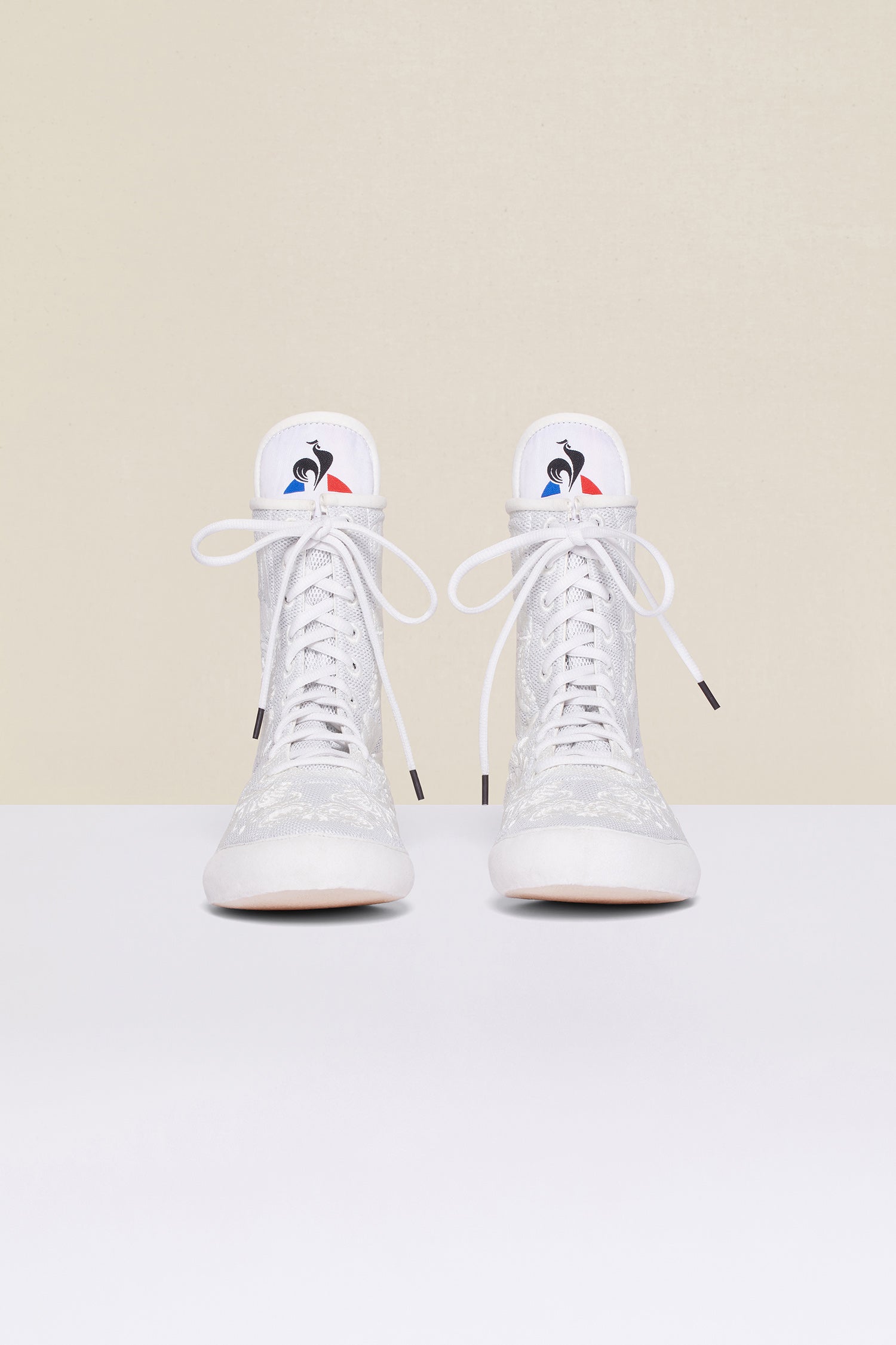 Patou - Embroidered high-top trainers - White - White - Couture florals are stepping in the ring!Ongoing collaboration between Patou and Le Coq Sportif. White high-top trainers inspired by classic boxing shoes. Monochrome floral embroideries. Patou logo engraved on the heel. Original Le Coq Sportif logo on the tongue. Flexible rubber sole with embossed Patou logo.