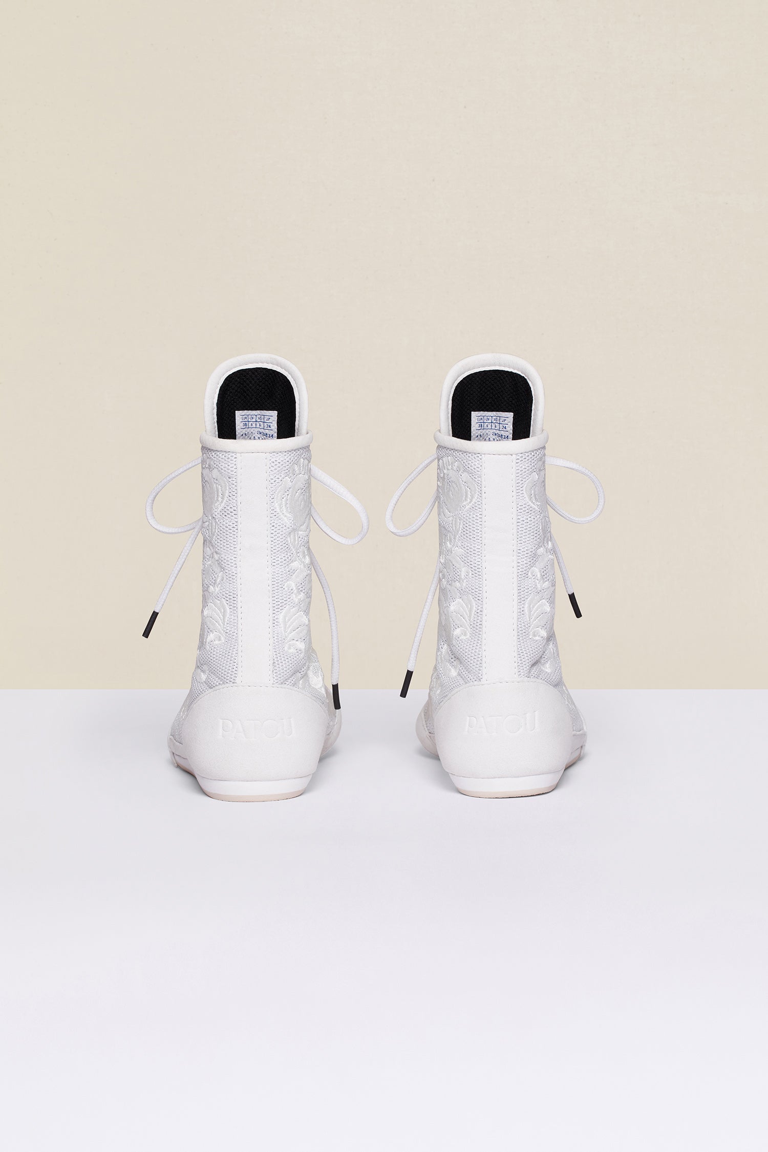 Patou - Embroidered high-top trainers - White - White - Couture florals are stepping in the ring!Ongoing collaboration between Patou and Le Coq Sportif. White high-top trainers inspired by classic boxing shoes. Monochrome floral embroideries. Patou logo engraved on the heel. Original Le Coq Sportif logo on the tongue. Flexible rubber sole with embossed Patou logo.