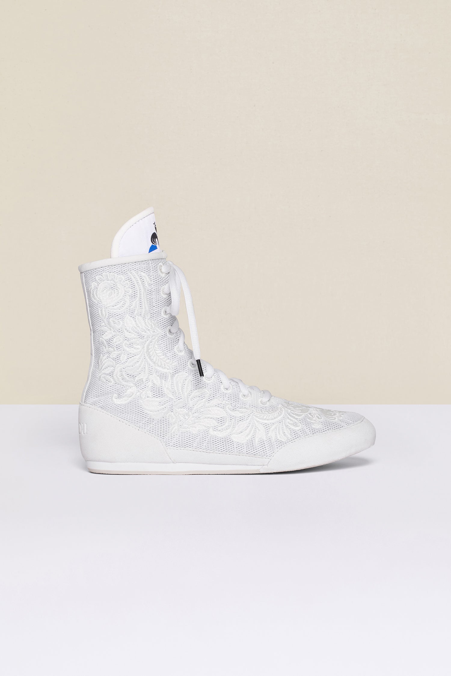 Patou - Embroidered high-top trainers - White - White - Couture florals are stepping in the ring!Ongoing collaboration between Patou and Le Coq Sportif. White high-top trainers inspired by classic boxing shoes. Monochrome floral embroideries. Patou logo engraved on the heel. Original Le Coq Sportif logo on the tongue. Flexible rubber sole with embossed Patou logo.