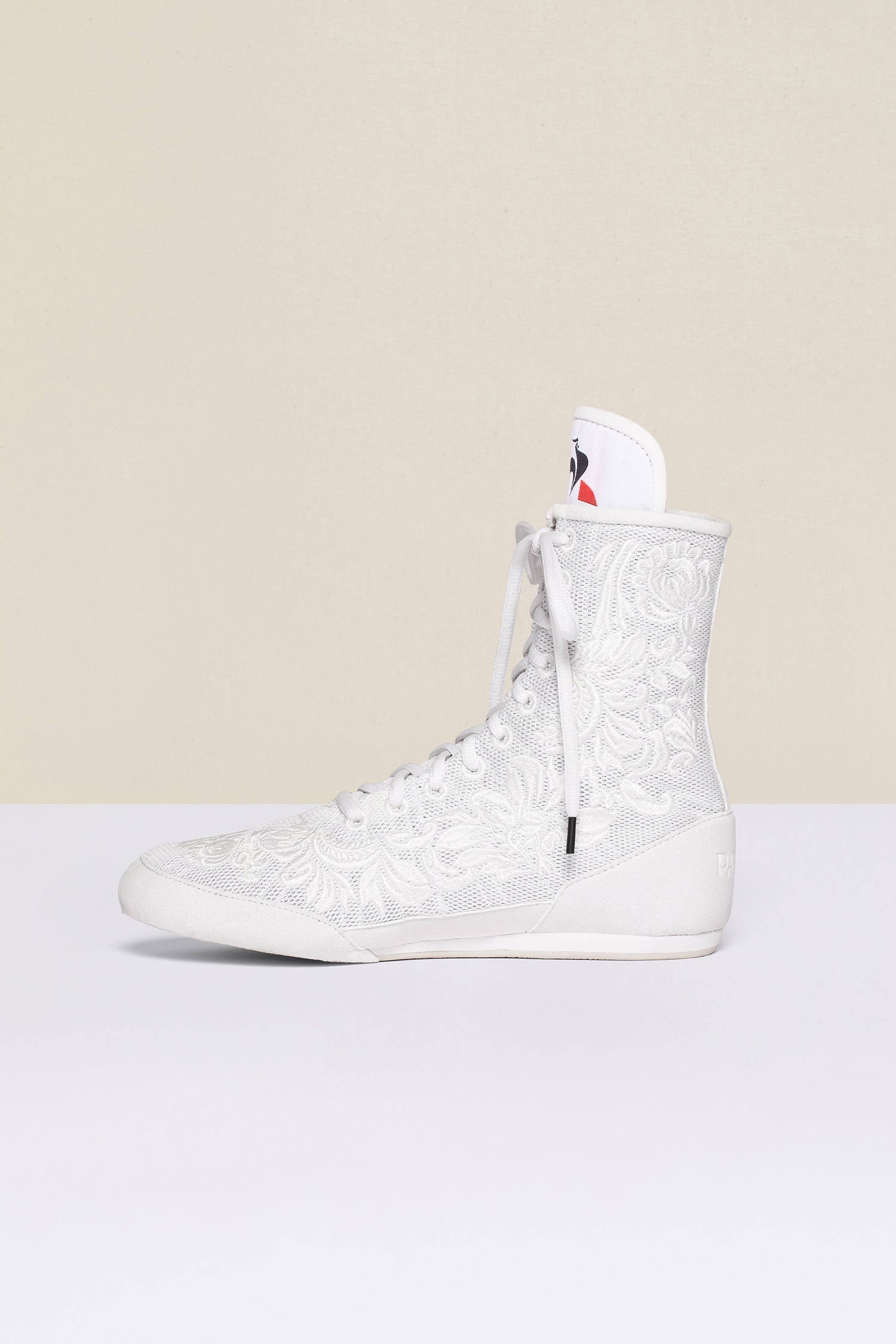 Patou - Embroidered high-top trainers - White - White - Couture florals are stepping in the ring!Ongoing collaboration between Patou and Le Coq Sportif. White high-top trainers inspired by classic boxing shoes. Monochrome floral embroideries. Patou logo engraved on the heel. Original Le Coq Sportif logo on the tongue. Flexible rubber sole with embossed Patou logo.