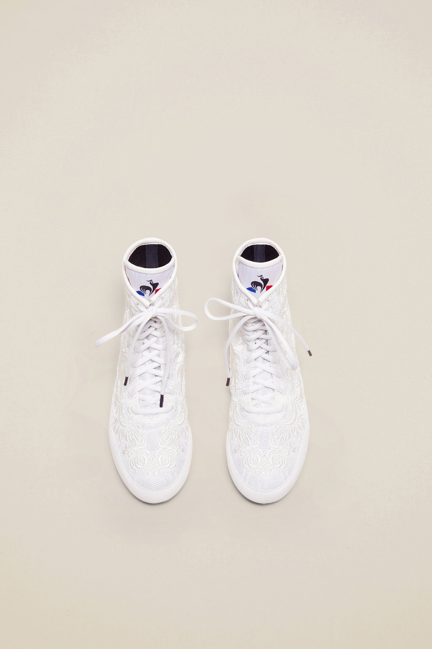 Patou - Embroidered high-top trainers - White - White - Couture florals are stepping in the ring!Ongoing collaboration between Patou and Le Coq Sportif. White high-top trainers inspired by classic boxing shoes. Monochrome floral embroideries. Patou logo engraved on the heel. Original Le Coq Sportif logo on the tongue. Flexible rubber sole with embossed Patou logo.