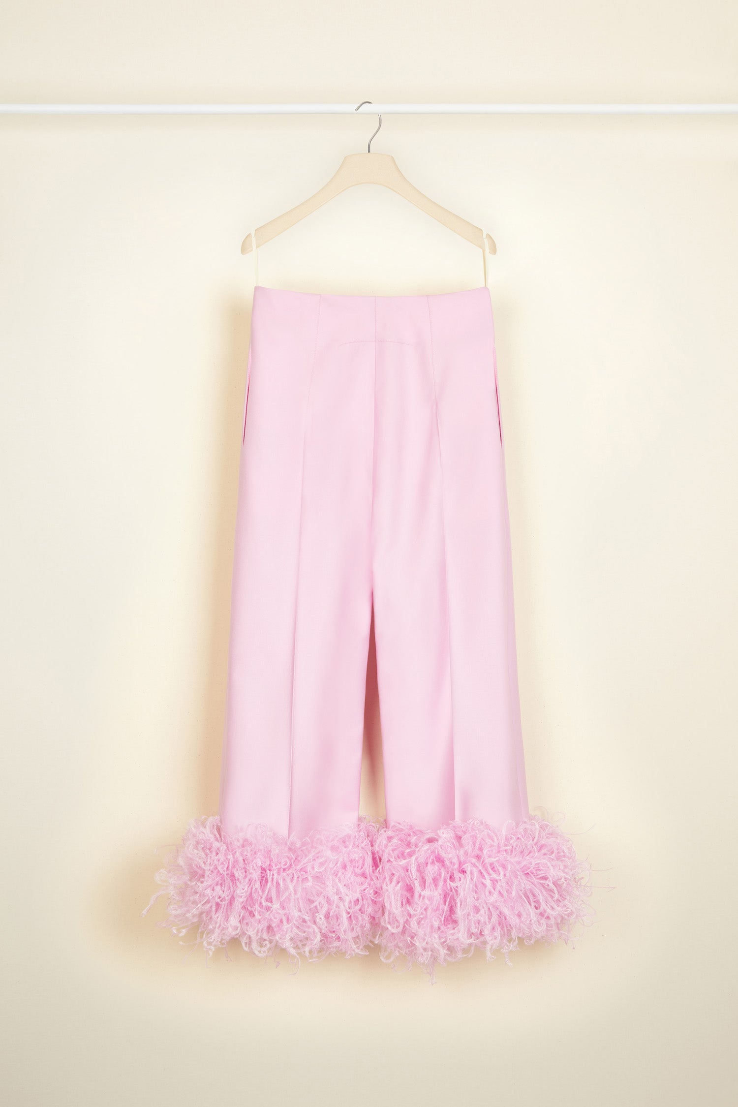 Patou - Trousers with feather hem in eco-friendly wool - Lavender - Flawless tailoring takes flight in a cloud of feathers.Lavender pink eco-friendly wool twill trousers. Cropped silhouette with a straight leg. Button fastening via gold-coloured engraved button at the front. Belt loops. Pockets at the sides. Signature curved seam at the back. Ostrich feather-embellished hem.