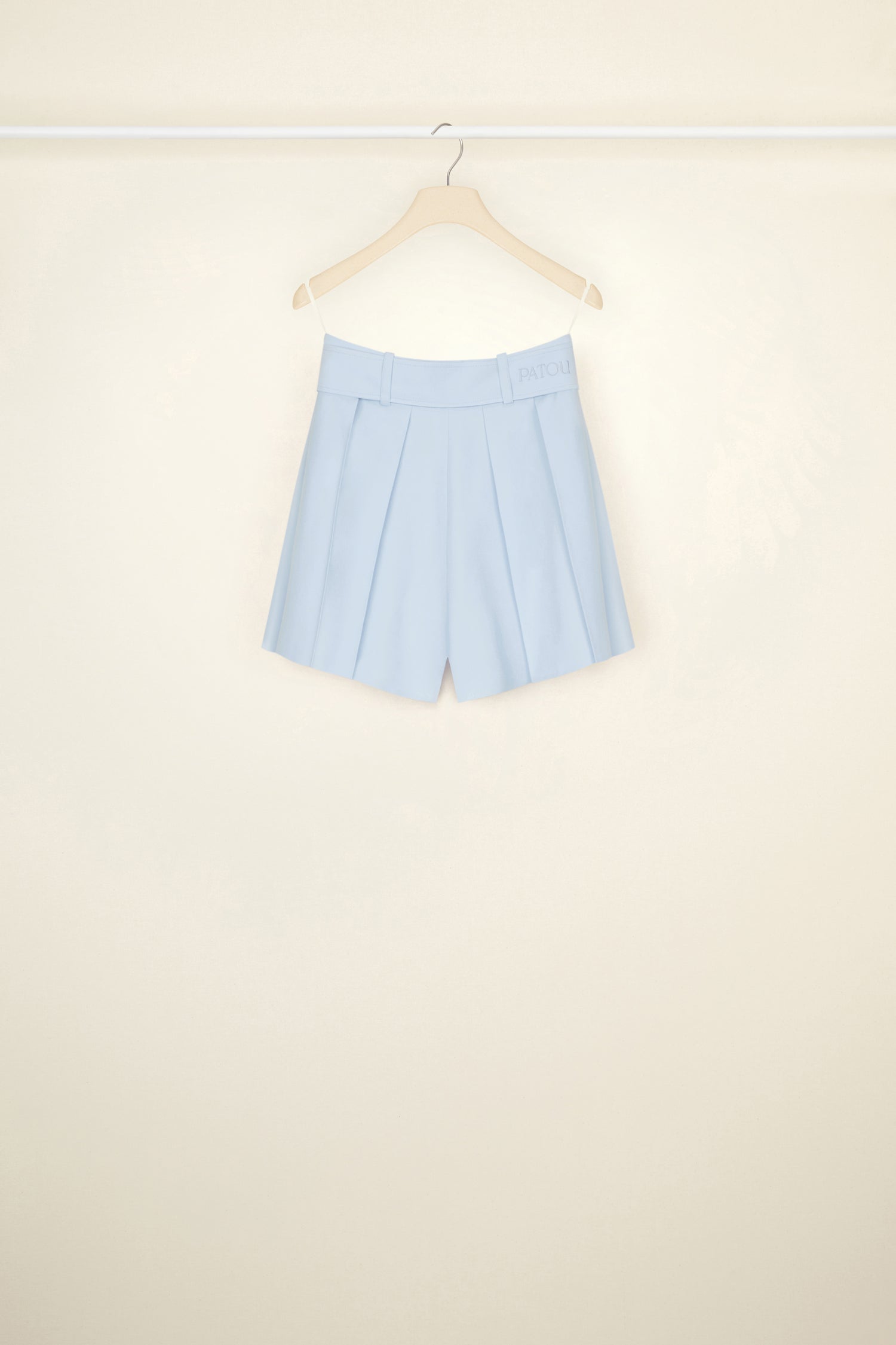 Patou - Belted pleated wool shorts - Sky Blue - Patou’s shortcut to chic. Sky Blue stretch virgin wool shorts. Adjustable belt at the waist with fabric-covered buckle. Patou lettering logo embroidered on the waistband. Belt loops. Wide pleats. Button fastening at the front. Pockets at the sides.
