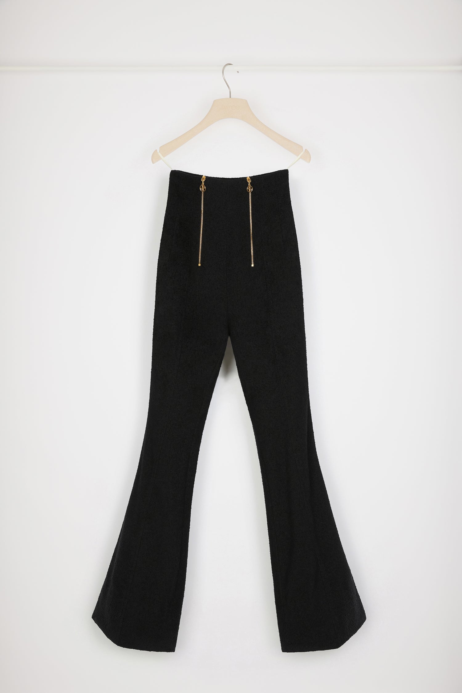 Patou - Flared trousers in cotton-blend tweed - Black - Flares with flair.Black cotton-blend tweed trousers. Fitted flared leg. High waist. Two gold-tone zips at the front with signature JP puller. Darts at the front and back. Stitched central creases at the front. Signature curved seam at the back.Close-fitting trousers.Spring-Summer 2023 Show - Look #04