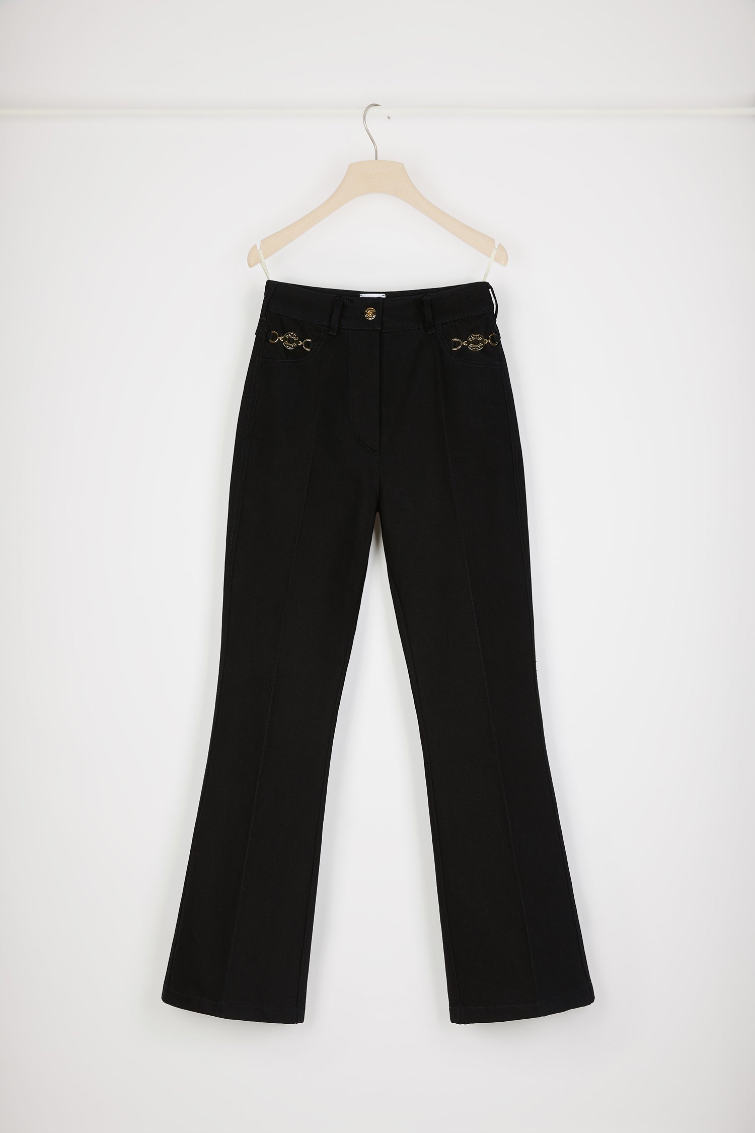 Patou - Pantalon évasé en denim bio - Black - Jean genie : le denim par Patou.Pantalon en denim noir. Jambe évasée. Taille mi-haute. Bouton doré gravé Patou. Passants de ceinture. Patou brodé à la taille. Pinces et plis à l'avant et au dos. Deux poches à l'avant avec médaillons dorés gravés Patou. Couture arrondie signature au dos.Le médaillon peut être enlevé.