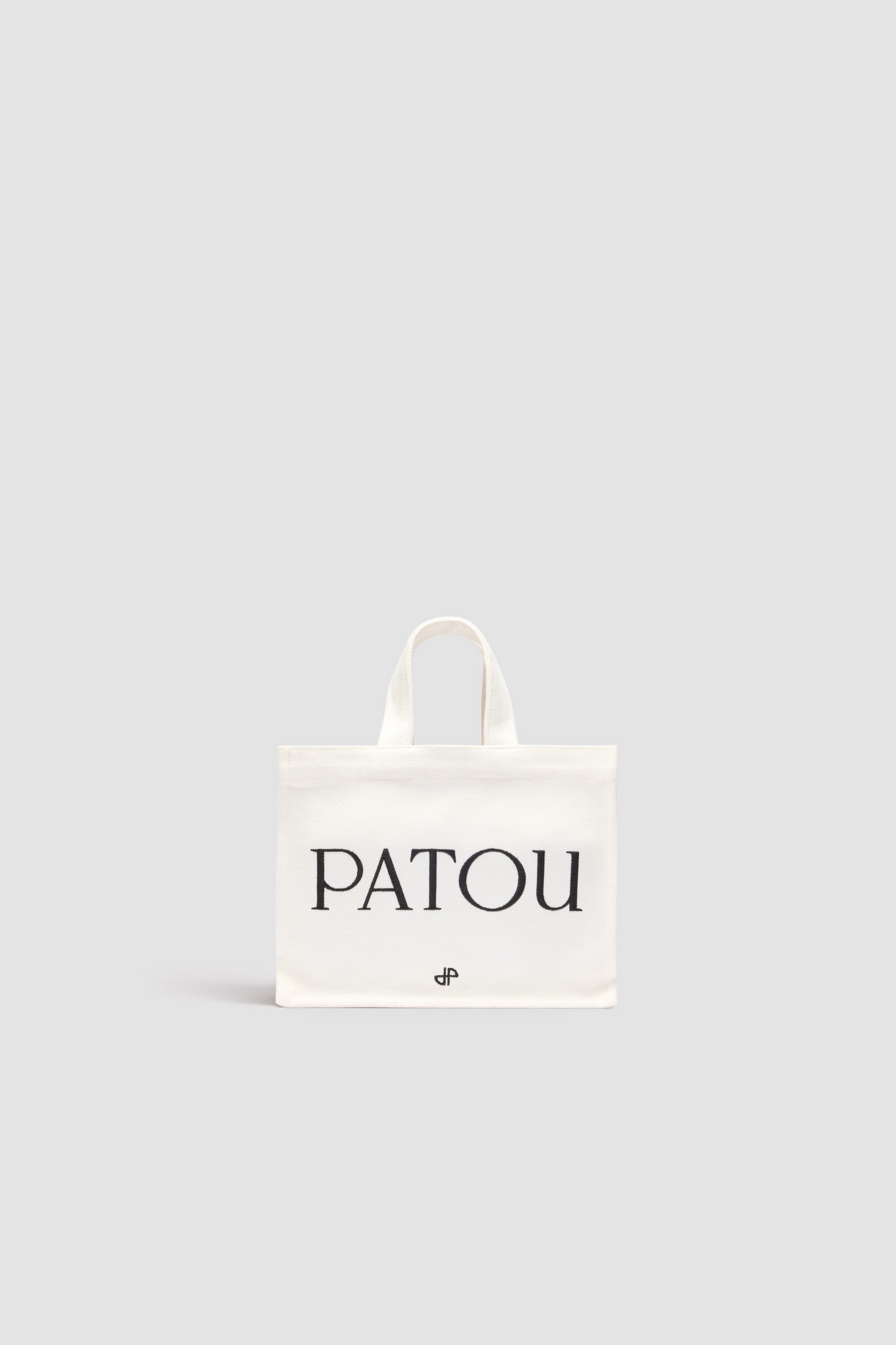 Patou - Small Patou tote in cotton canvas - White - White cotton canvas tote. Embroidered Patou and JP. Embossed shoulder strap with gold buttons. Two top handles. Can be carried by hand or on the shoulder.