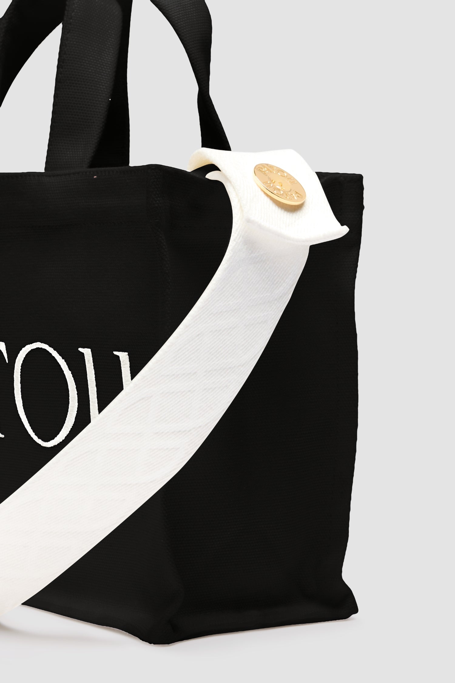 Patou - Small Patou tote in cotton canvas - Black - Black cotton canvas tote. Embroidered Patou and JP. Embossed shoulder strap with gold buttons. Two top handles. Can be carried by hand or on the shoulder.