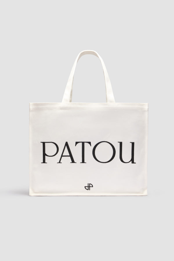 Patou - Large Patou tote in cotton canvas - White - White cotton canvas tote. Embroidered Patou and JP. Embossed shoulder strap with gold buttons. Two top handles. Can be carried by hand or on the shoulder.