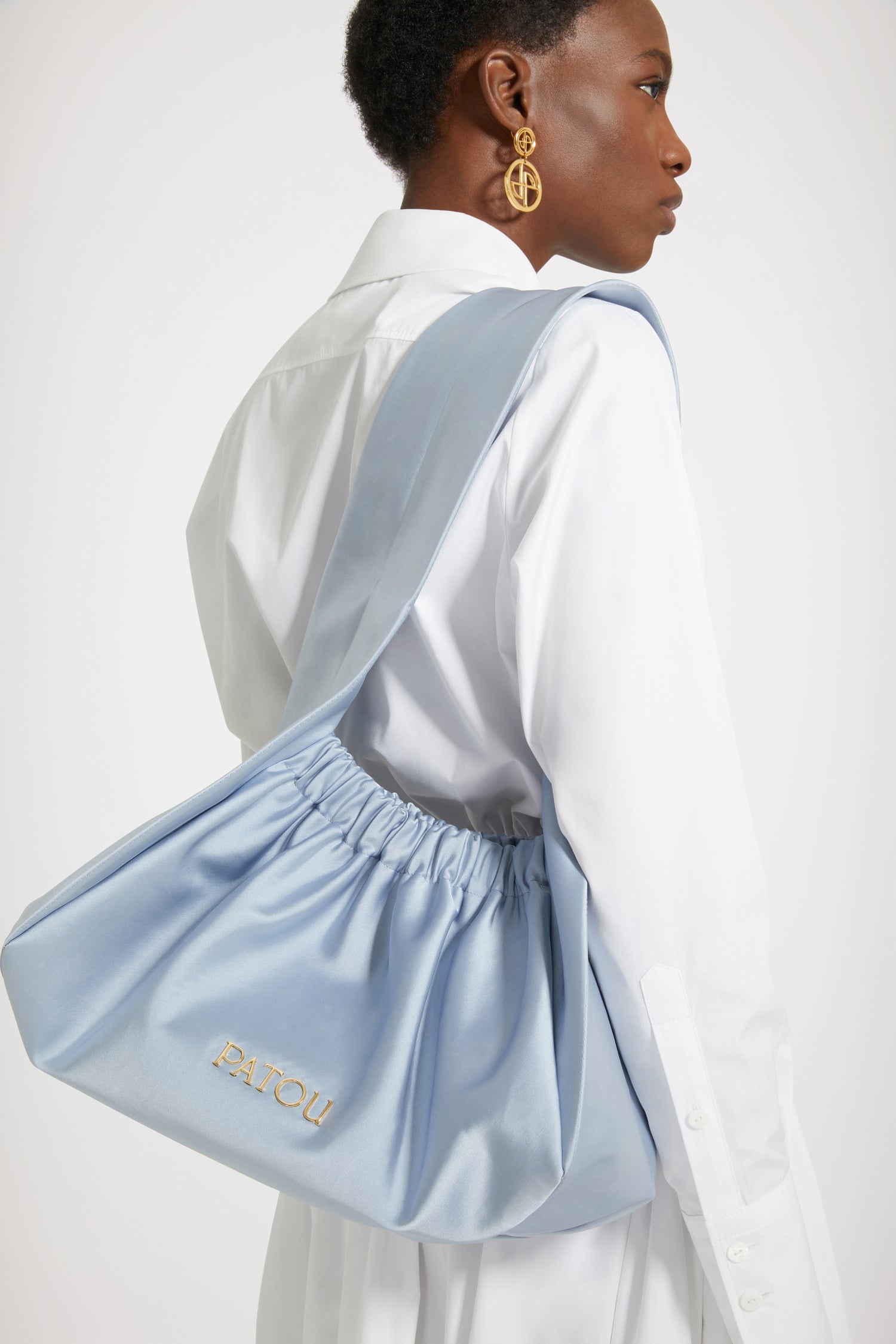 Patou - Le Biscuit large bag - Alaska Blue - Origami à Paris!Alaska Blue cotton-blend satin bag. Large version. Hobo shape with wide built-in strap. Elasticated opening. Gold-tone metal Patou logo. Cotton lining.