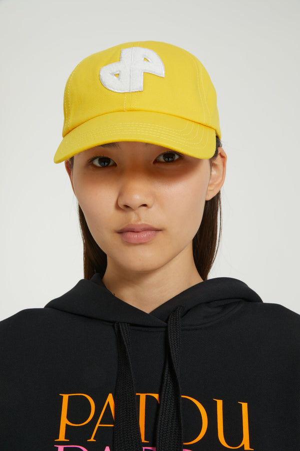 Patou - JP cap in cotton - Yellow - Do you Patou?Yellow cotton baseball hat. JP patch at the front. Elasticated strap at the back. Unisex style.Sizing:S: 55 cm circumferenceM: 57 cm circumferenceL: 59 cm circumference