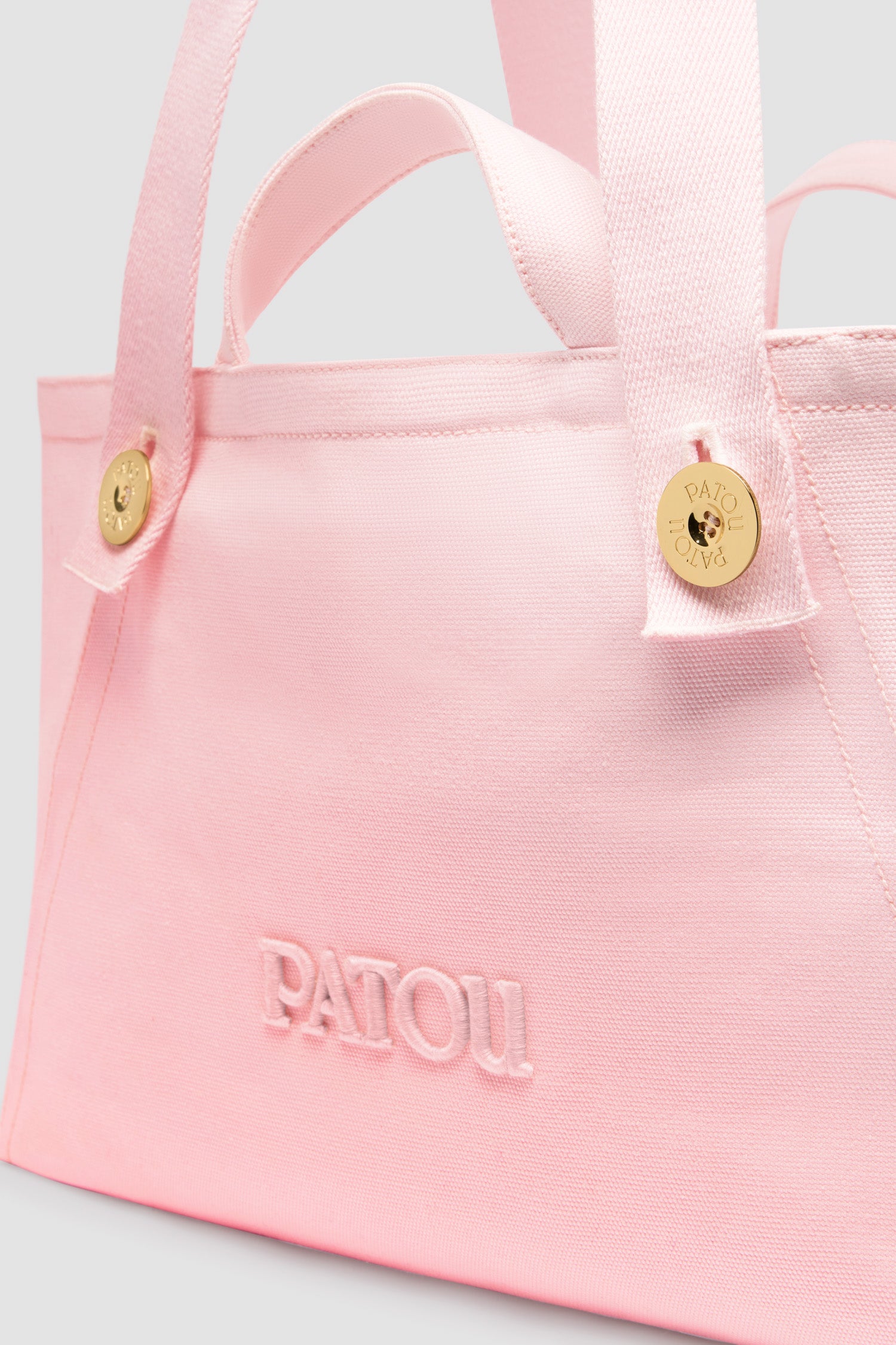 Patou - Large Patou logo trapeze tote in cotton canvas - Primrose Pink - Primrose Pink cotton canvas tote. Large version. Trapeze shape. Two top handles, two shoulder straps attached via gold-tone Patou logo-engraved buttons. Embroidered Patou logo at the front.