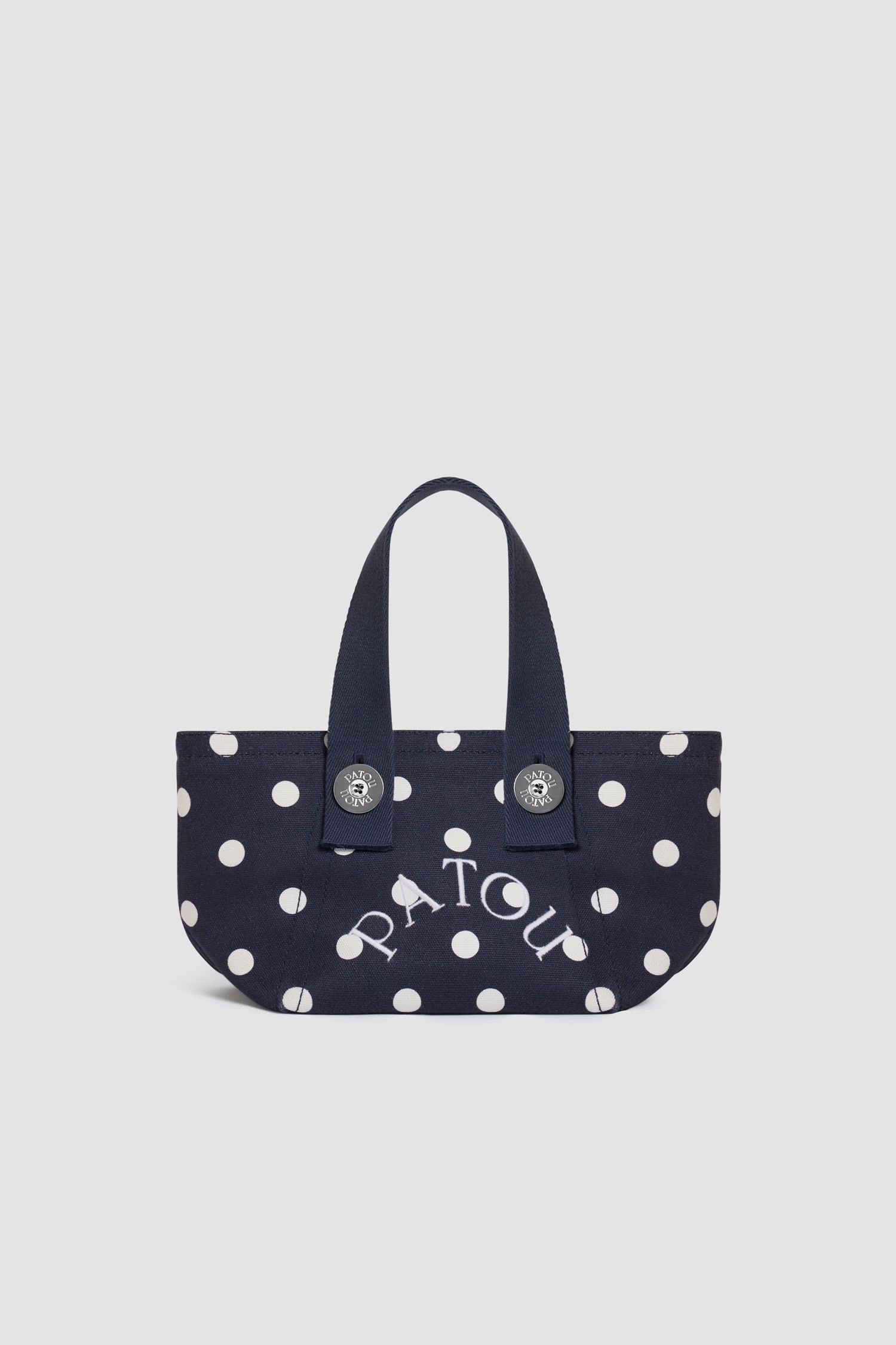 Patou - Borsa tote a trapezio PM in cotone biologico - Meteorite Blue - Borsa tote a trapezio piccola in cotone biologico blu navy a pois bianchi. Logo Patou ricamato bianco. Manici blu navy. Chiusura con bottone a pressione.
