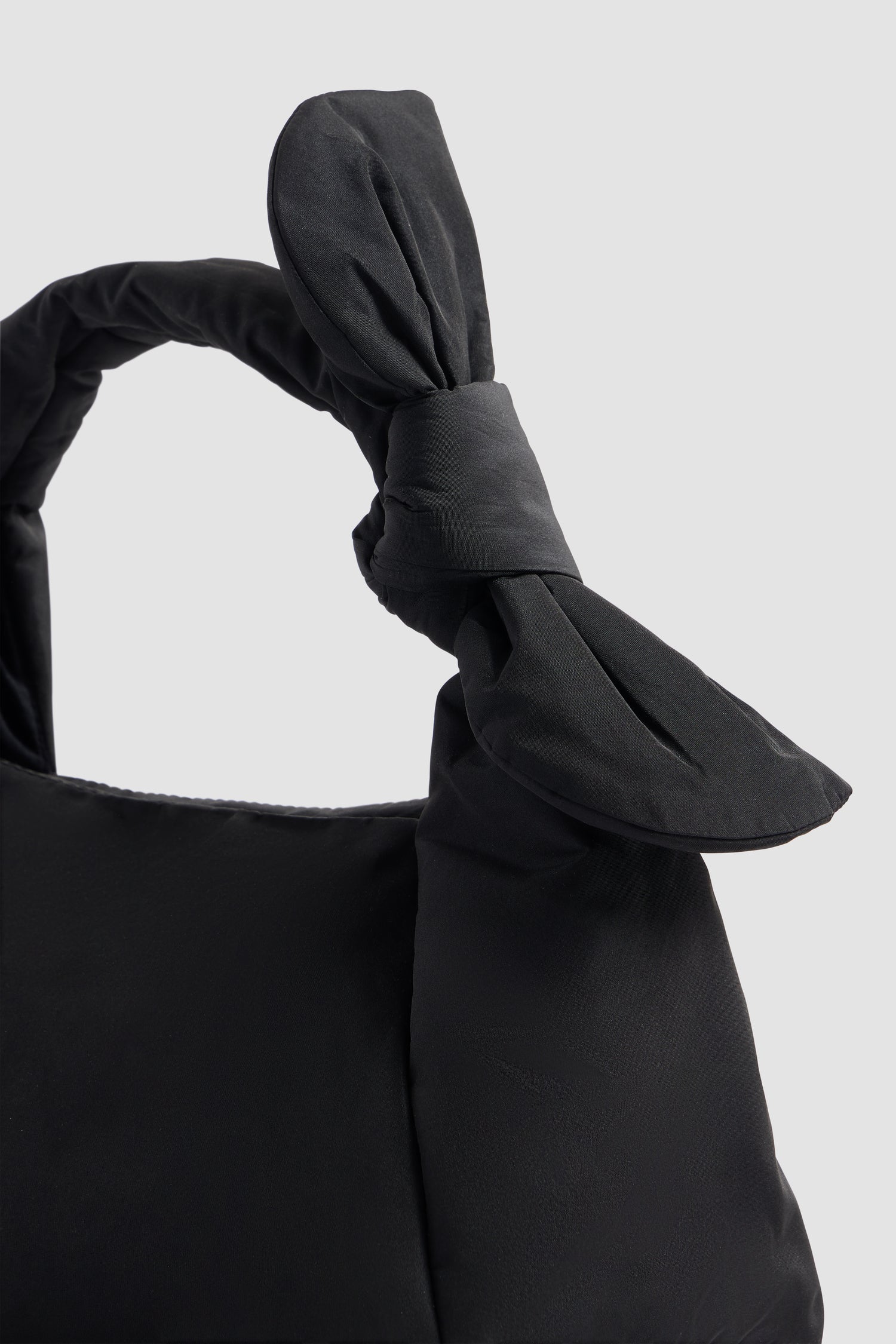 Patou - Knotted bag in recycled polyester - Black - Black bag in recycled polyester. Soft shape. Short handle. Knotted detail. Quilted volume. Patou logo on the front.