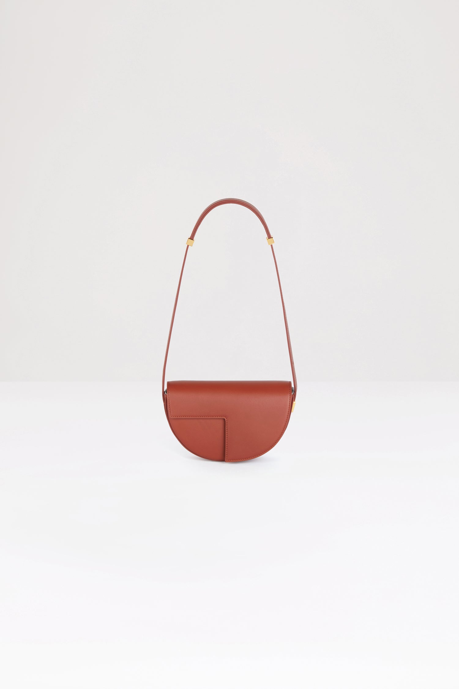 Patou - Le Petit Patou bag in leather - Maya Mountain - A smaller take on everyone&amp;#39;s favourite piece of Patou!Maya Mountain brown leather handbag. Crafted using unique materials sourced from unused high-quality leather hides. 120 limited numbered edition. Half-circle shape with geometric cut-outs inspired by the JP monogram. Gold-tone hardware with Patou-engraved detail at the side. Adjustable strap that allows it to be worn on the shoulder, across the body or carried by hand. Magnetic closure with gold-tone JP detail. Internal compartment. Eco lining.Measures: 20cm (length), 13cm (height), 5cm (depth)
