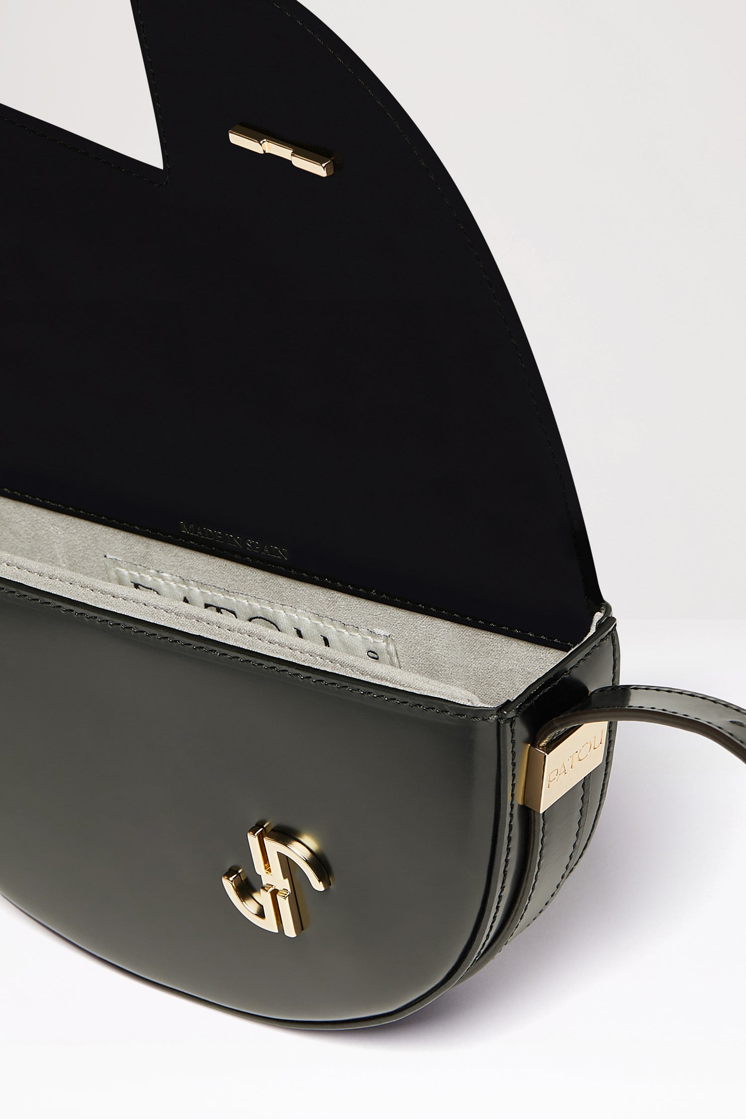 Patou - Le Petit Patou bag in leather - Black - A smaller take on everyone&amp;#39;s favourite piece of Patou!Black leather handbag. Crafted using unique materials sourced from unused high-quality leather hides. 80 limited numbered edition. Half-circle shape with geometric cut-outs inspired by the JP monogram. Gold-tone hardware with Patou-engraved detail at the side. Adjustable strap that allows it to be worn on the shoulder, across the body or carried by hand. Magnetic closure with gold-tone JP detail. Internal compartment. Eco lining.Measures: 20cm (length), 13cm (height), 5cm (depth)