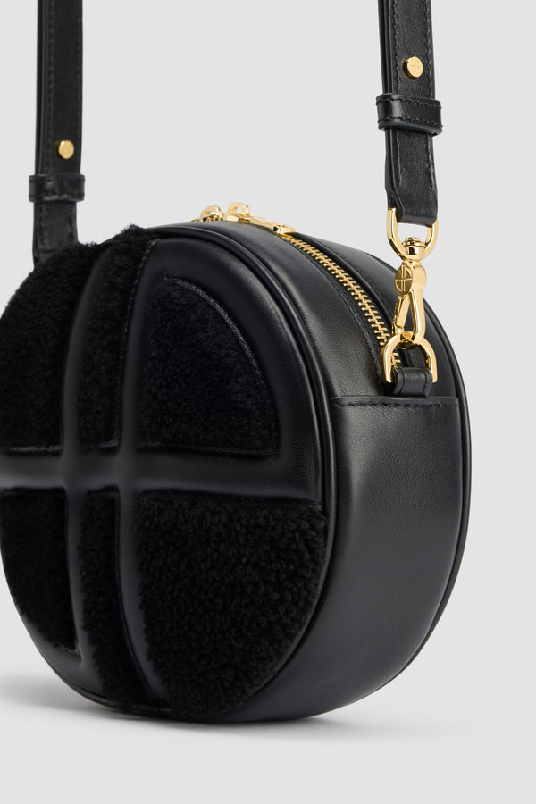 Patou - Le JP bag in leather and shearling - Black - Black leather and shearling handbag. Oval shape with a foam-padded 3D JP monogram at the front. Embossed Patou logo at the back. Two-way zip fastening. Single inside pocket. Detachable and adjustable strap. Gold-tone hardware. Eco lining.Measures: 21 cm (length), 18 cm (height), 7 cm (depth)Adjustable strap: 66 cm-110 cm