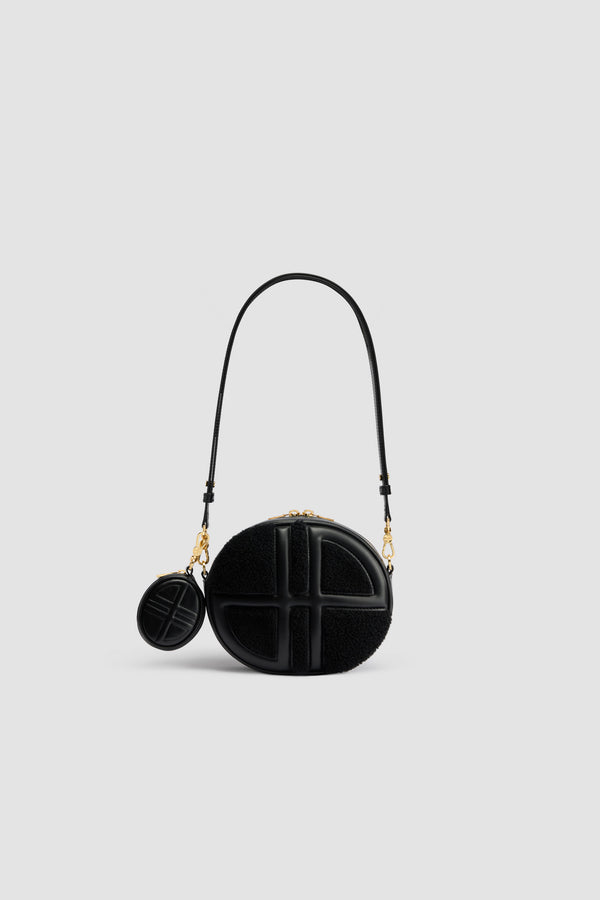 Patou - Le JP bag in leather and shearling - Black - Black leather and shearling handbag. Oval shape with a foam-padded 3D JP monogram at the front. Embossed Patou logo at the back. Two-way zip fastening. Single inside pocket. Detachable and adjustable strap. Gold-tone hardware. Eco lining.Measures: 21 cm (length), 18 cm (height), 7 cm (depth)Adjustable strap: 66 cm-110 cm