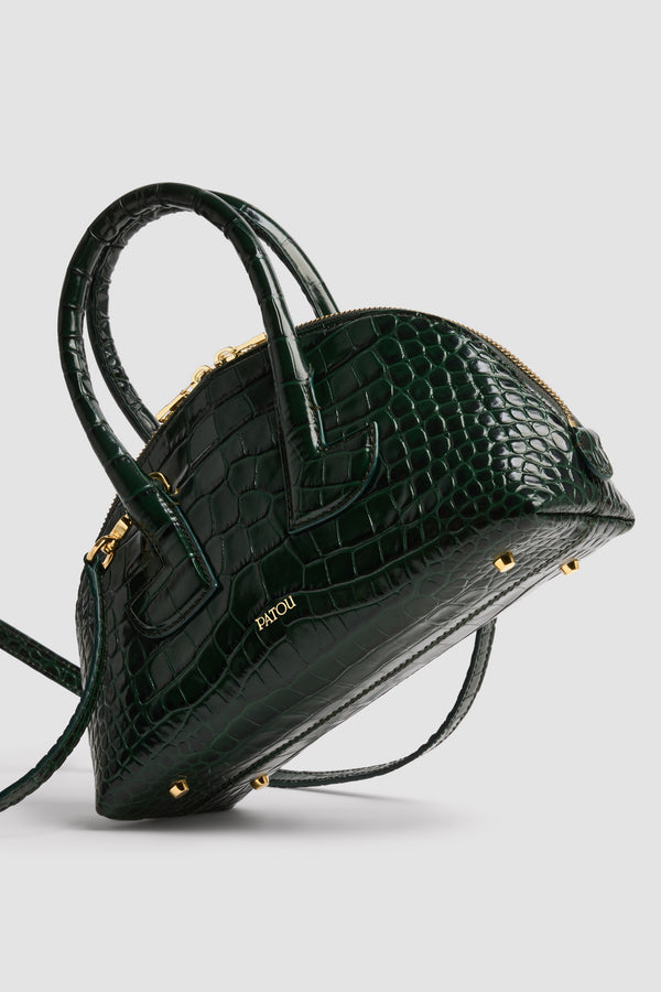 Patou - Borsa Le Patou Bowling in pelle di coccodrillo goffrata - Garden Green - Borsa in pelle di coccodrillo goffrata Garden Green. Forma bowling. Doppio manico con dettagli geometrici. Tracolla rimovibile. Chiusura con zip oro a doppio cursore. Logo Patou oro goffrato sul davanti. Piedini in metallo oro.