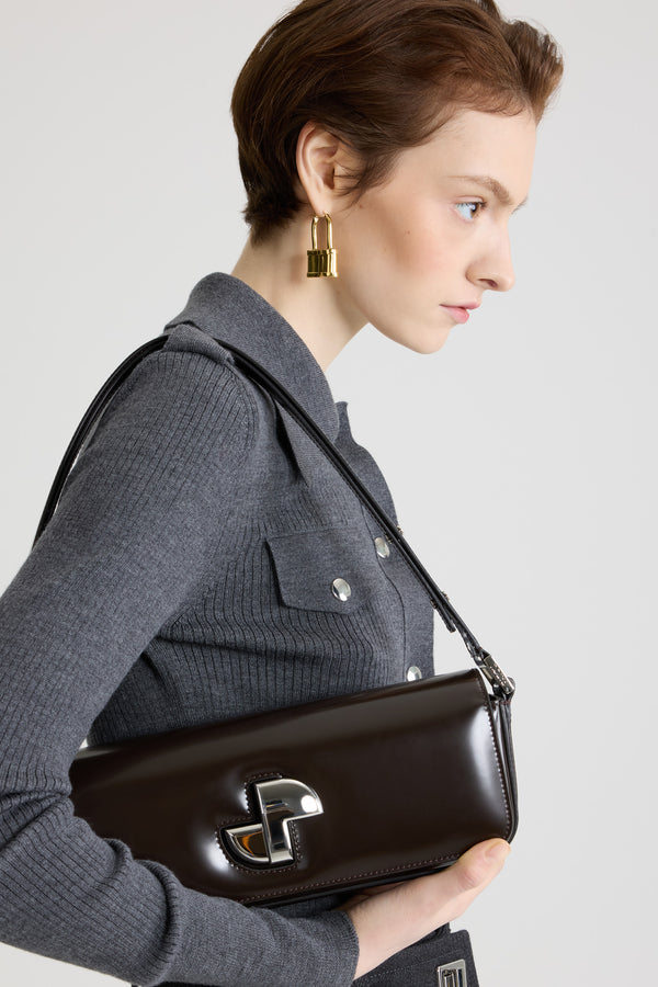 Patou - Le Long Lock bag in leather - Smoked Ebony - Smoked Ebony glossy leather handbag. Classic day bag inspiration with an elongated shape. Gold Art Deco JP twist clasp at the front. Adjustable strap that allows it to be worn short or long. Leather lining.