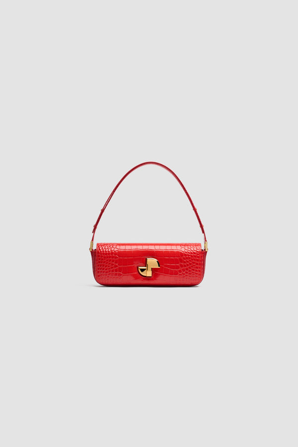 Patou - Le Long Lock bag in crocodile-embossed leather - Babylone Red - Babylone Red crocodile-embossed leather handbag. Classic day bag inspiration with an elongated shape. Gold Art Deco JP twist clasp at the front. Adjustable strap that allows it to be worn short or long. Leather lining.