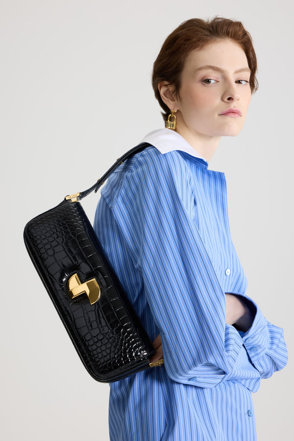 Patou - Le Long Lock bag in crocodile-embossed leather - Black - Black crocodile-embossed leather handbag. Classic day bag inspiration with an elongated shape. Gold Art Deco JP twist clasp at the front. Adjustable strap that allows it to be worn short or long. Leather lining.