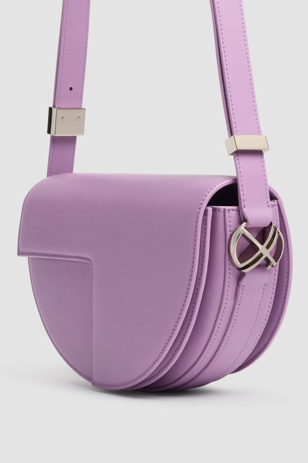 Patou - Le Patou Leather Bag - Lavender - Le Patou bag in violet leather. Half-moon shape. Adjustable and removable shoulder strap. Flap closure with golden JP monogram.