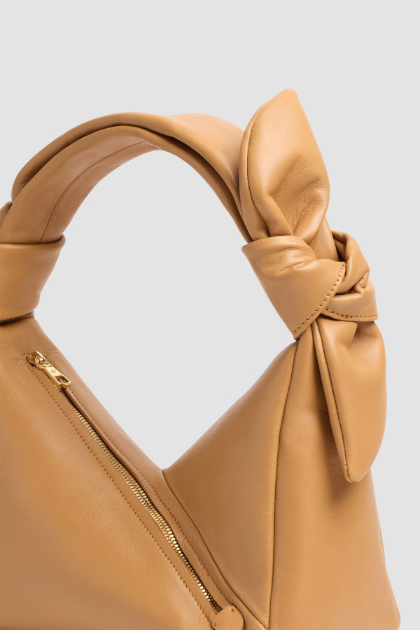 Patou - Leather Bag - Dune - Leather bag in sand-colored leather. Triangular shape. Knotted handle. Side zip closure.