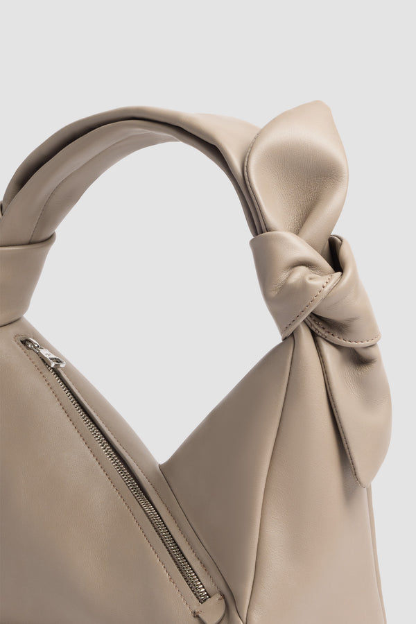 Patou - Leather Bag - Pebble Grey - Leather bag in grey leather. Triangular shape. Knotted handle. Side zip closure.