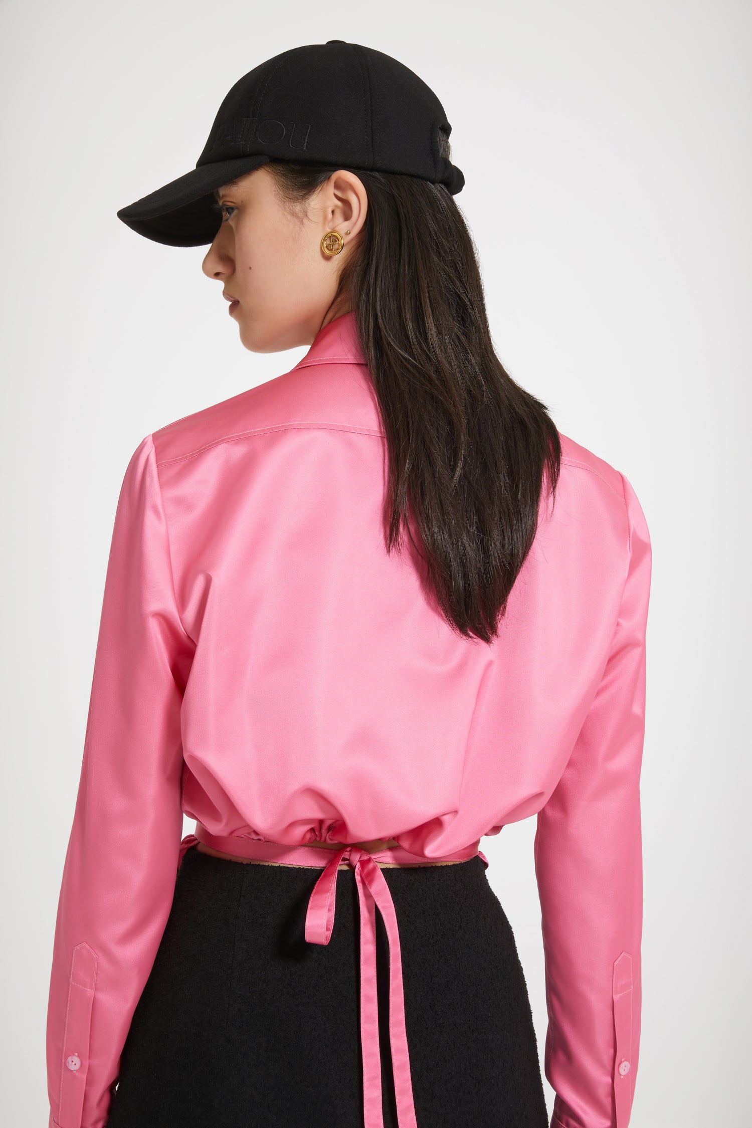 Patou - Cut-out cropped shirt in eco-friendly satin - Hot Pink - A new silhouette that hits all the right notes.Hot Pink recycled polyester satin shirt. Cropped silhouette with violin-shaped cut-outs at the sides. Concealed button fastening. Belt at the waist with tunnel at the back. Pleating at the cuffs. Buttoned cuffs.