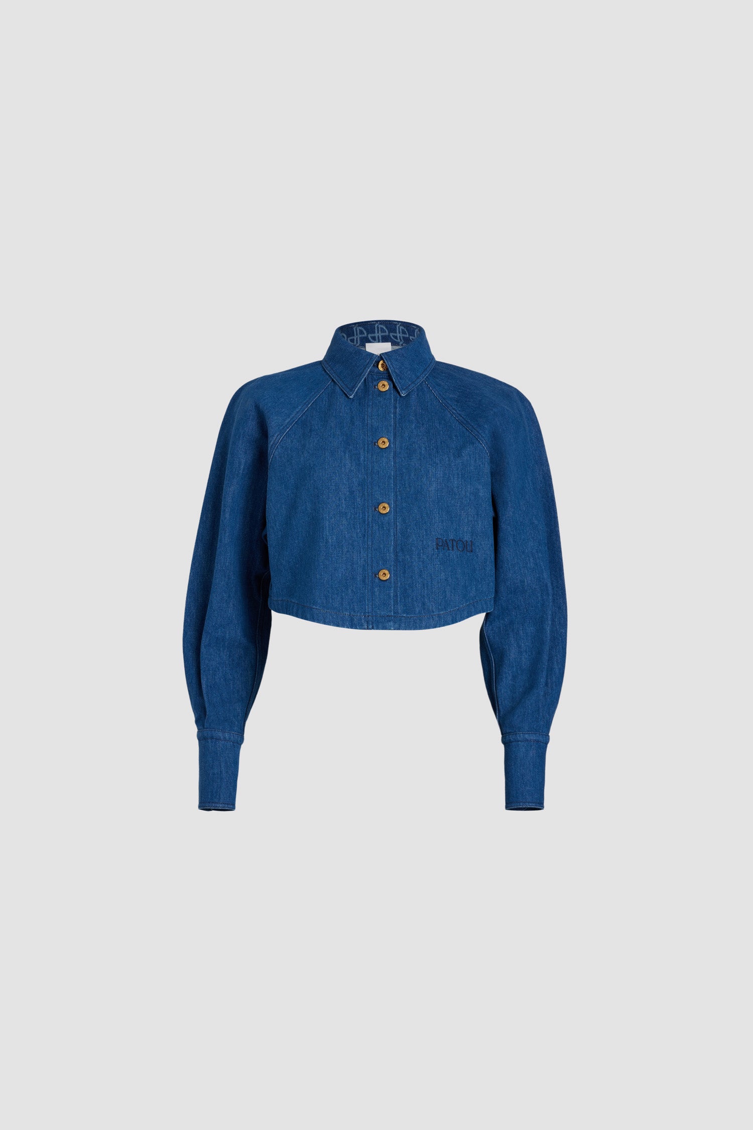 Patou - Cropped shirt in organic cotton denim - Stonewash - Stonewash organic cotton denim shirt. Cropped length. Shirt collar with JP monogram at the inside. Gold-tone Patou-engraved buttons. Embroidered Patou at the front. Raglan sleeves. Buttoned cuffs.