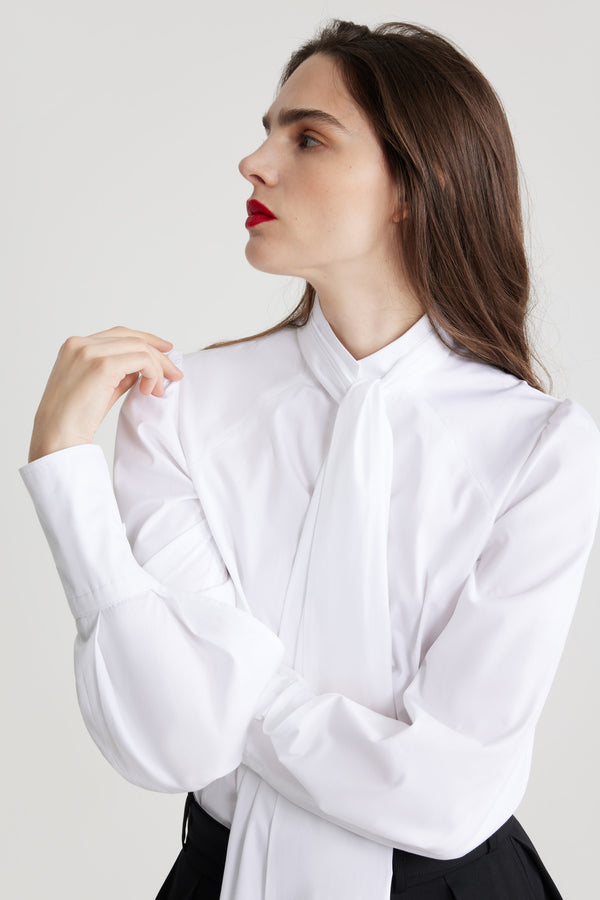 Patou - Lavallière blouse in organic cotton - White - White organic cotton blouse. Stand collar with removable lavallière bow. JP-engraved mother-of-pearl buttons. Volume raglan sleeves with puff shoulders and buttoned French cuffs.