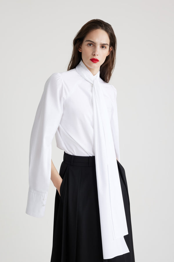 Patou - Lavallière blouse in organic cotton - White - White organic cotton blouse. Stand collar with removable lavallière bow. JP-engraved mother-of-pearl buttons. Volume raglan sleeves with puff shoulders and buttoned French cuffs.