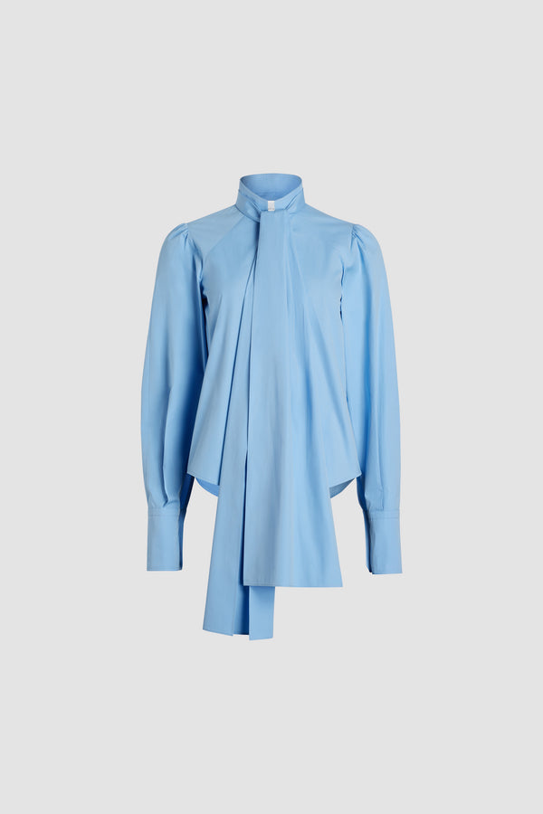 Patou - Lavallière blouse in organic cotton - Airy Blue - Airy Blue organic cotton blouse. Stand collar with removable lavallière bow. JP-engraved mother-of-pearl buttons. Volume raglan sleeves with puff shoulders and buttoned French cuffs.