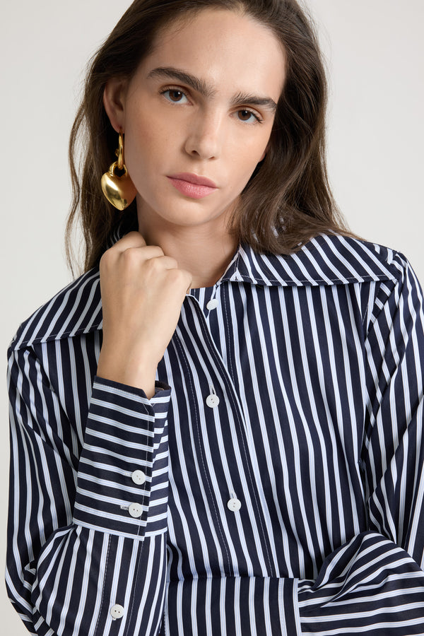 Patou - Fitted shirt in printed organic cotton poplin - Navy Stripes - Navy organic cotton poplin shirt. Striped pattern. Fitted violin-inspired silhouette. Wide collar. Button front fastening. Buttoned cuffs. Embroidered JP monogram at the front. Asymmetric front to back hem.